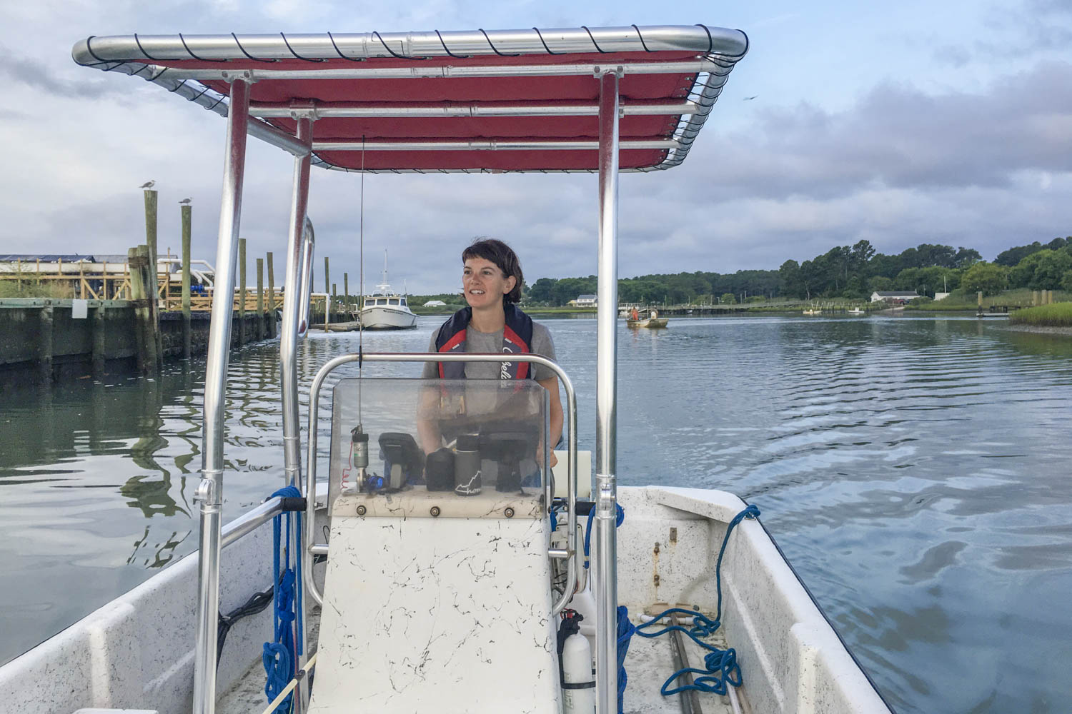 Cora Johnston driving a boat on the water