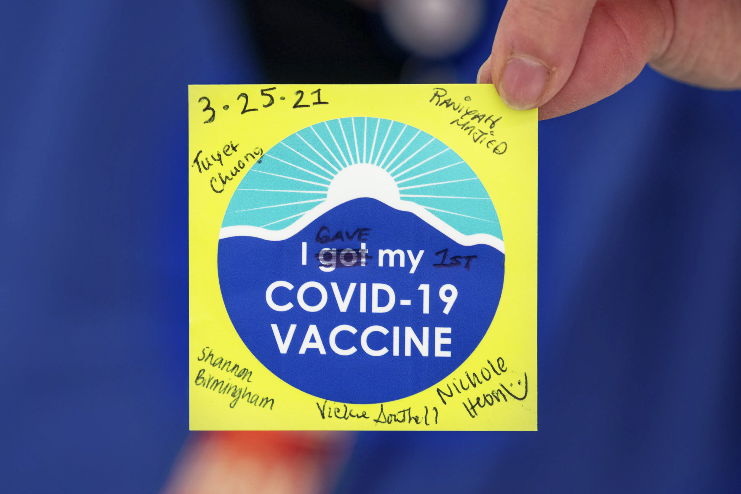 signed stickers with date and the sticker reads I gave my 1st covid-19 vaccine
