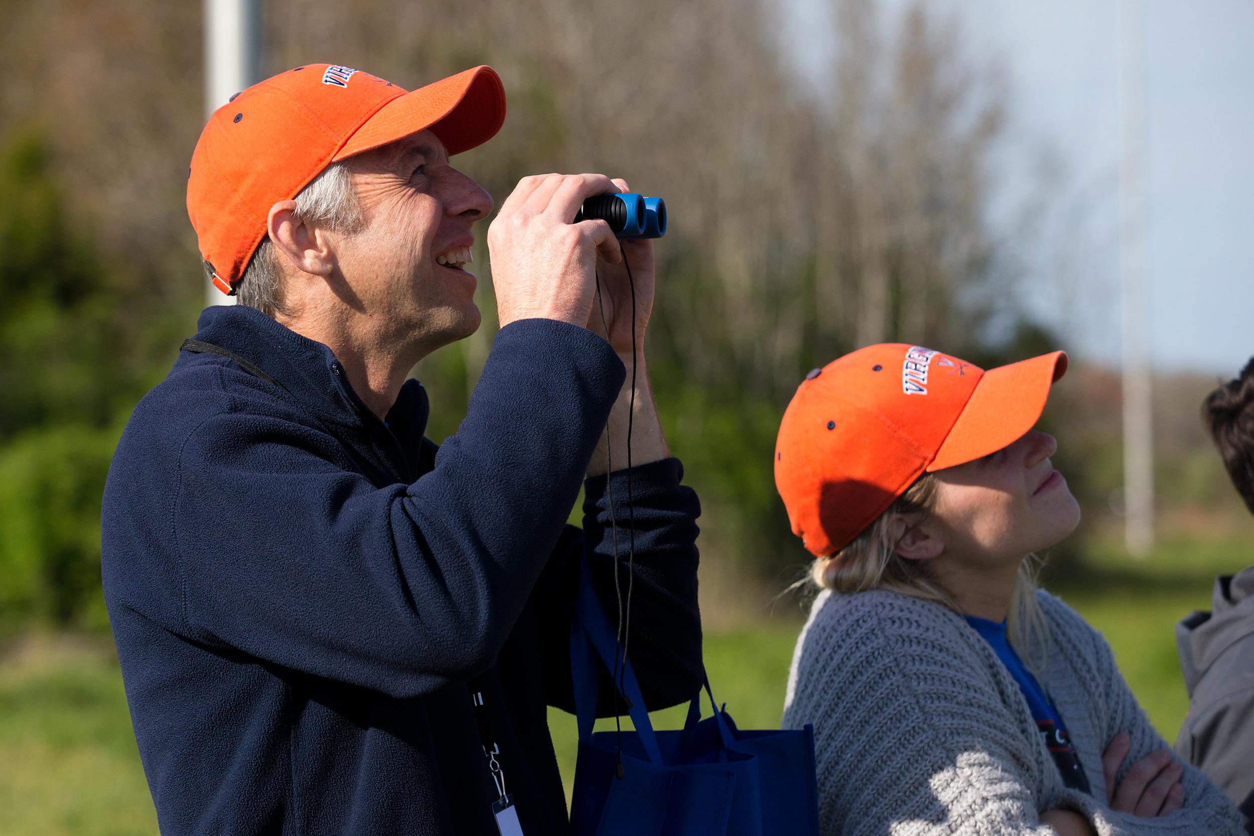 Chris Goyne uses binoculars to watch a launch 