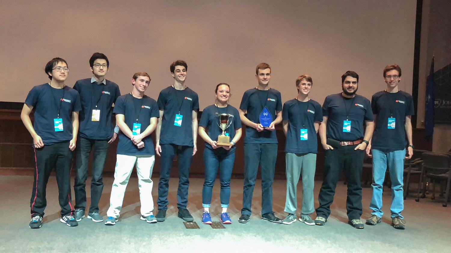  UVA cyber defense team holds their trophies on stage