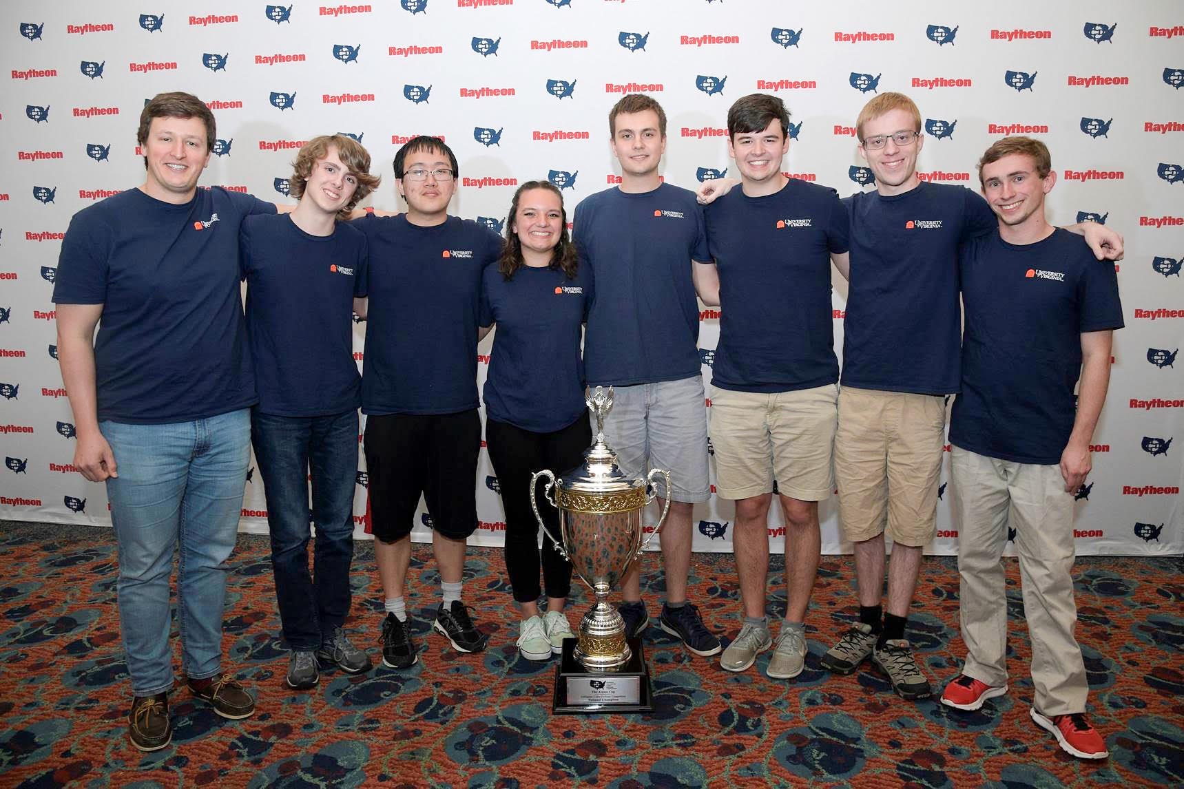 Cyber defense team group photo with their trophy