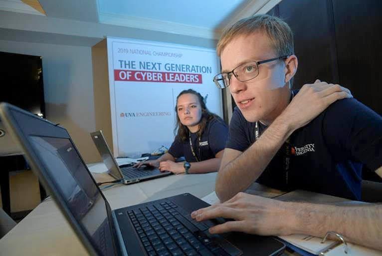 Mariah Kenny and Conner Steenrod  work on computers