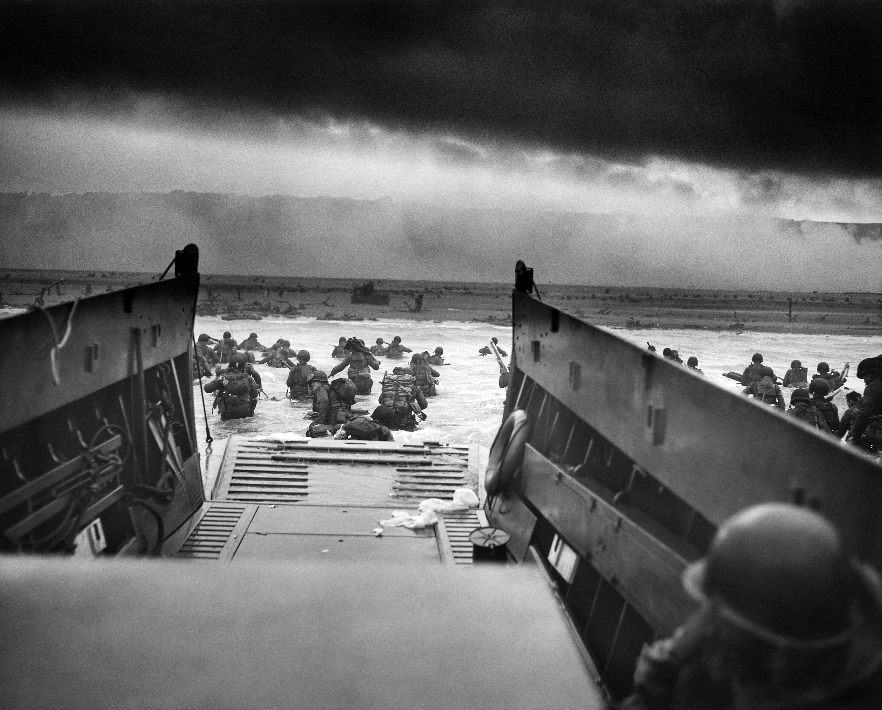Black and White image of Troops leaving their boats at Normandy