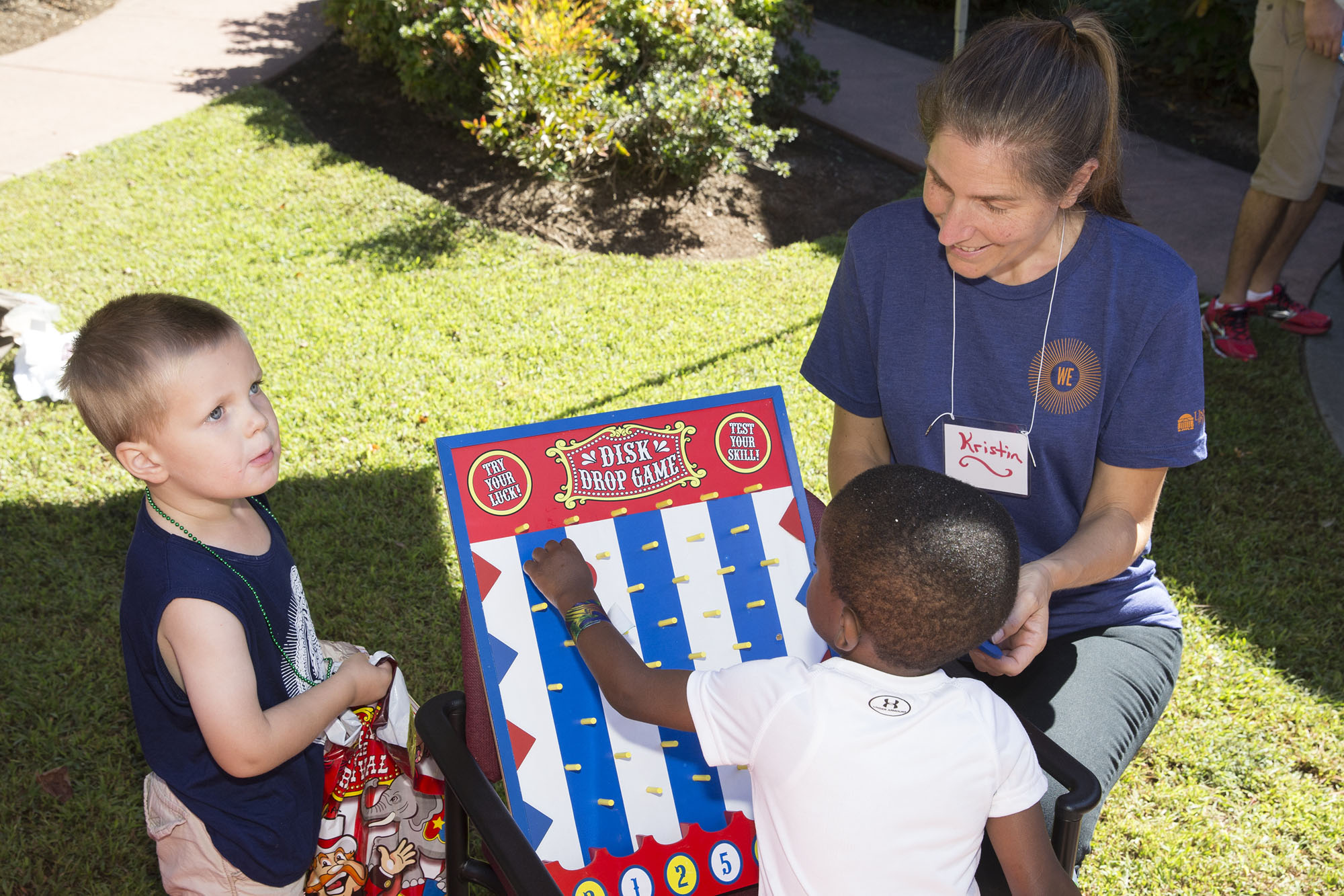 Preschoolers play games with a volunteer from U.Va.’s Office for Diversity and Equity at a carnival at JABA.