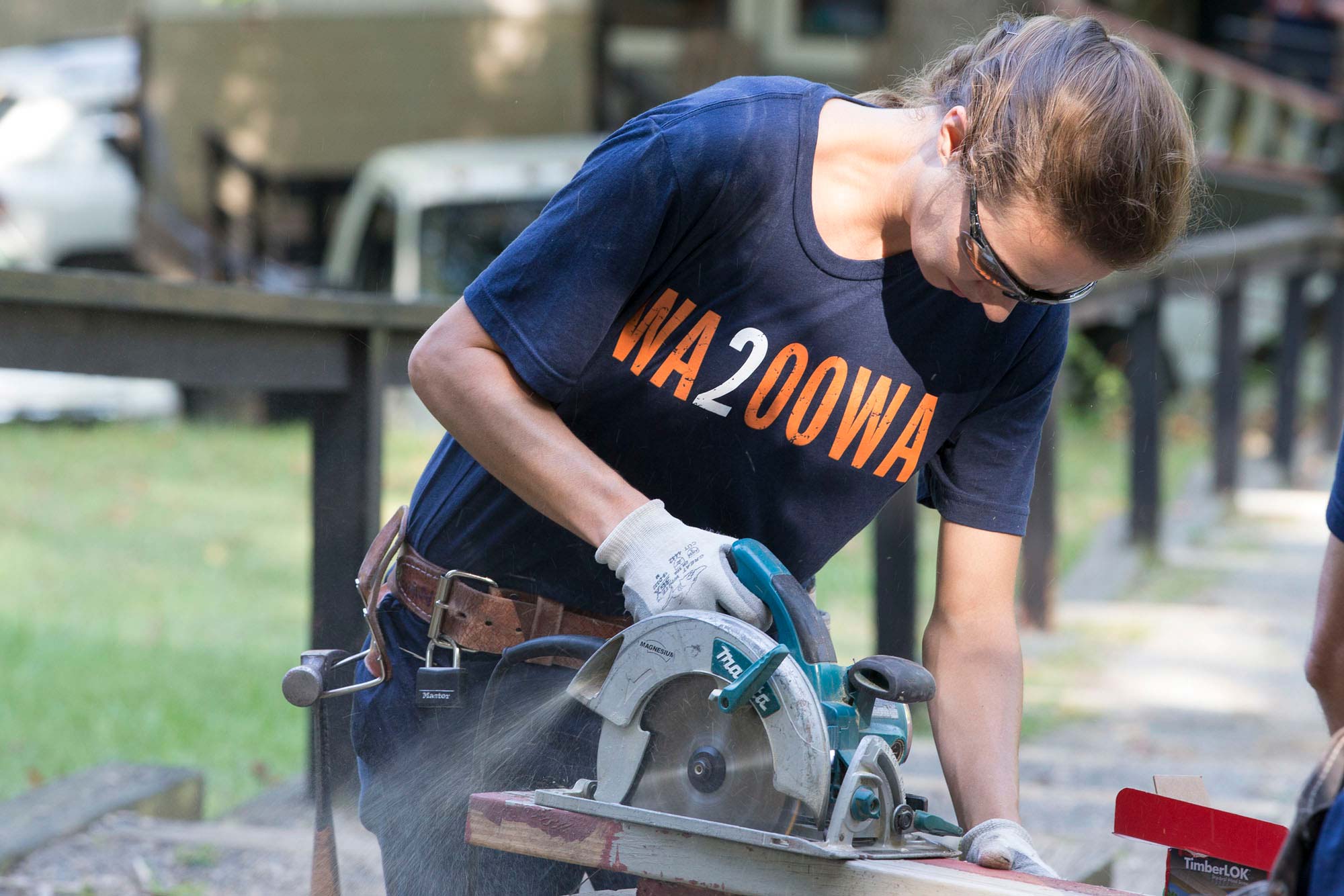 Anne Tufts, a carpenter apprentice at Facilities Management, cuts a frame for a doorway at Camp Holiday Trails.