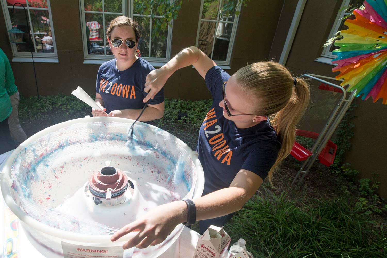 Meredith Gillet and Emily Tate spin cotton candy onto sticks