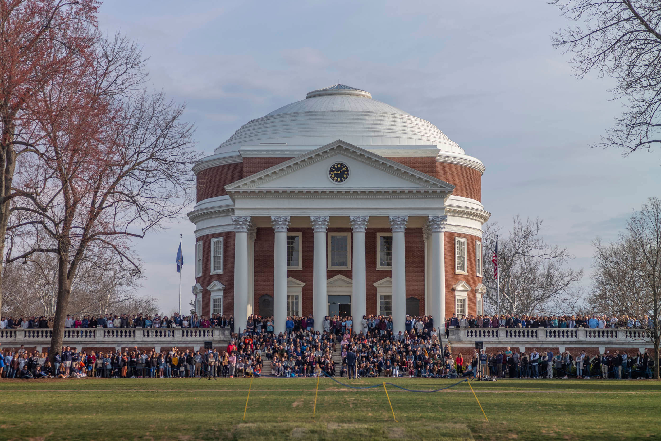 The Rotunda filled with people on its sidewalks and steps all pose together for a group photo
