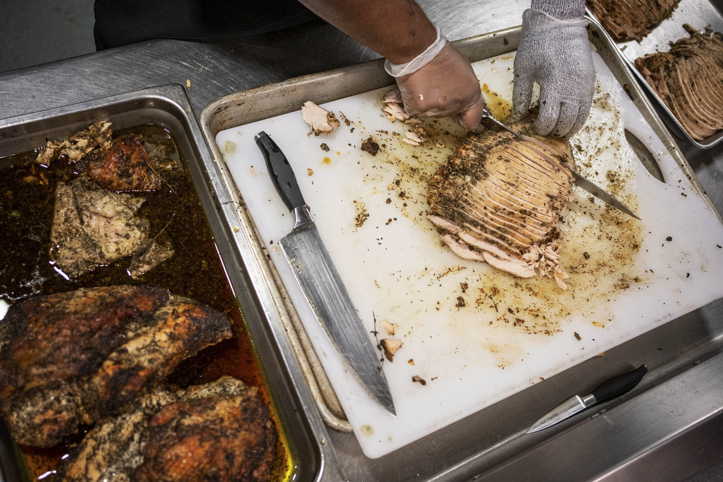 Food Service Member slicing Herbed Turkey for Thanksgivin