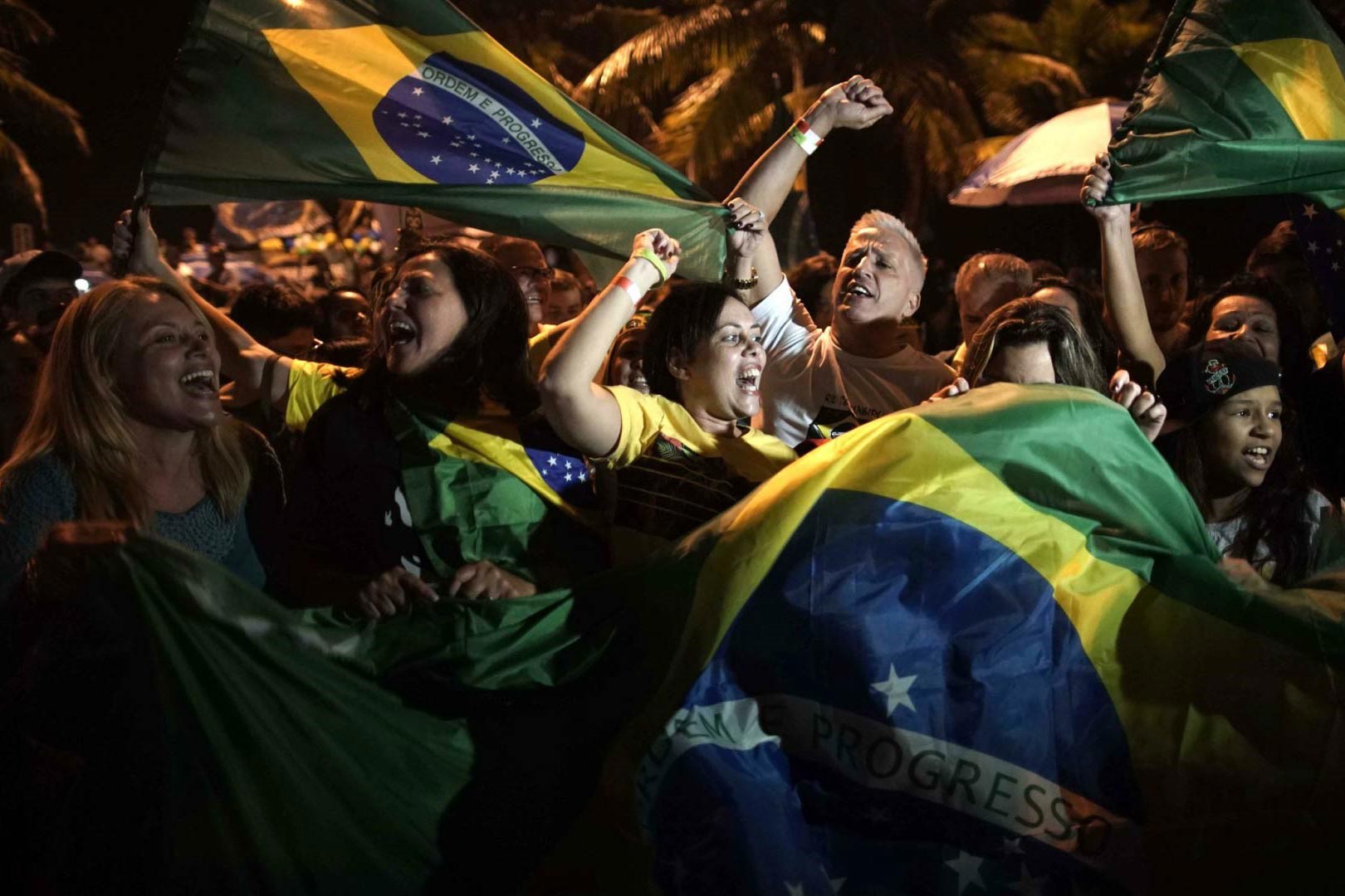 Protestors in Brazil in the streets with flags and people screaming