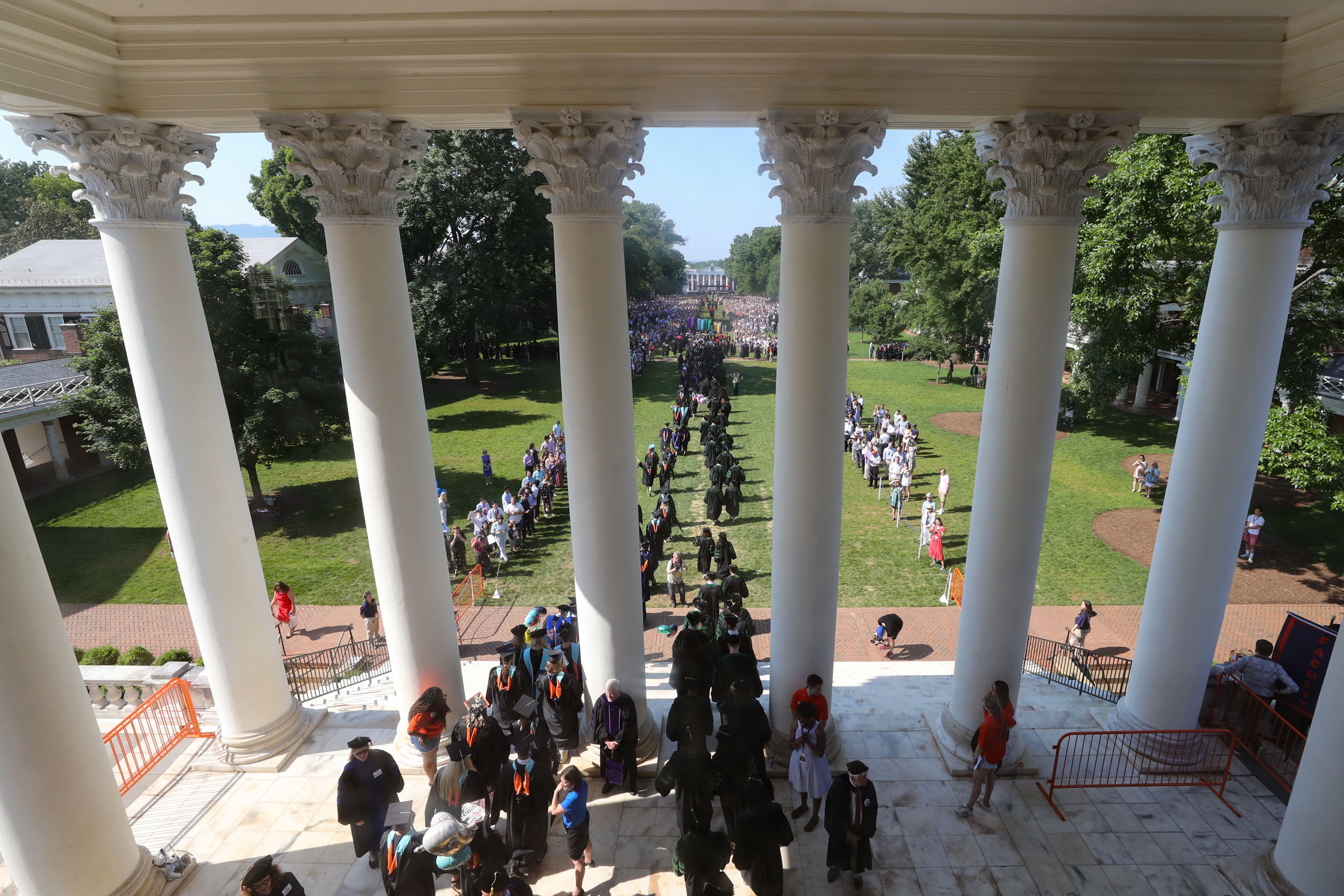 Graduates walking out of the Rotunda on to the Lawn