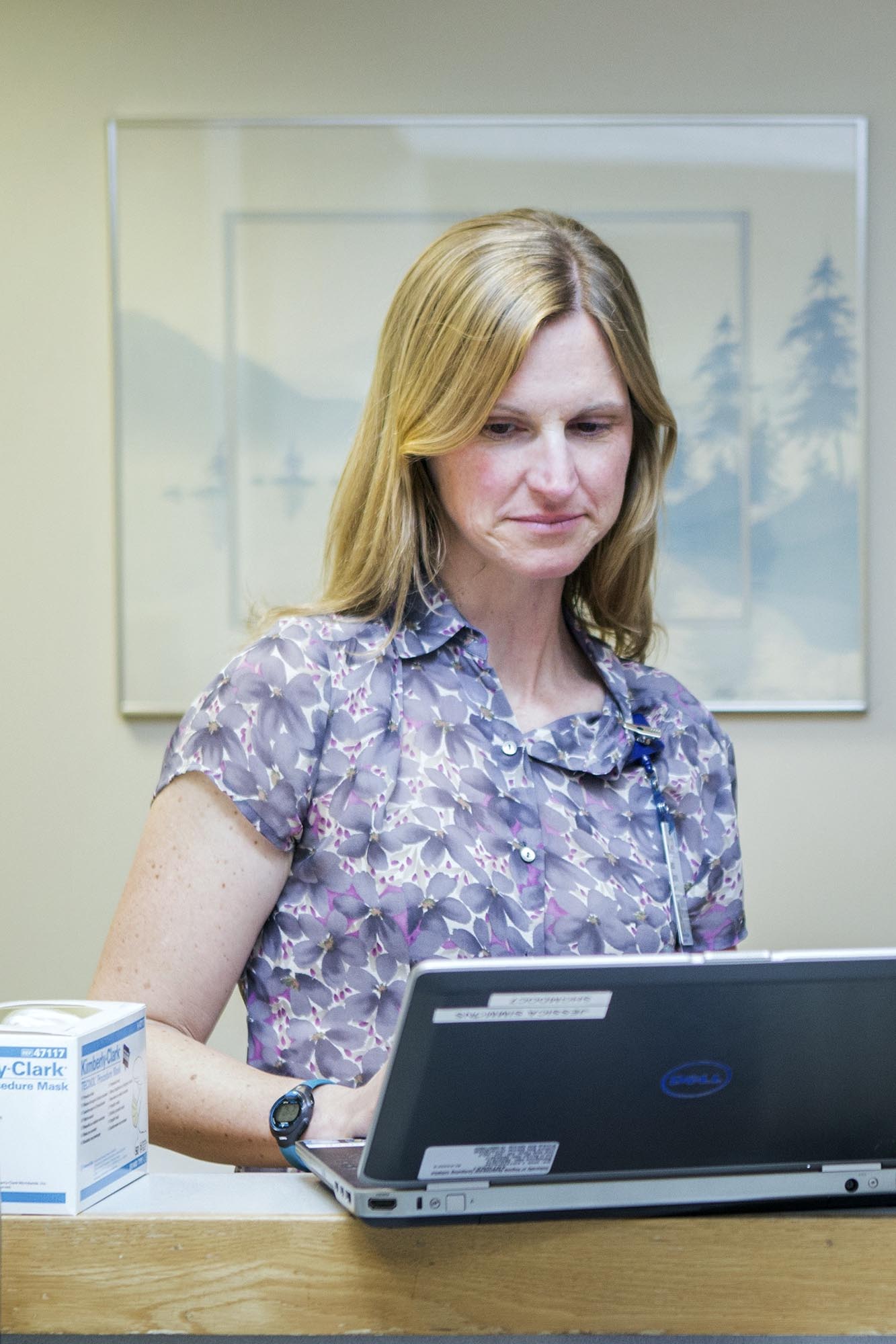 Dr. Jessica Simmons standing while looking at a computer monitor