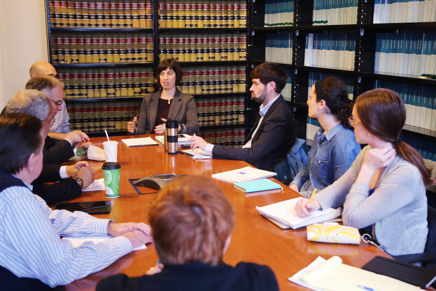 Angela Ciolfi, a legal director at Legal Aid Justice Center’s Charlottesville office, talks strategy with the Drive Down the Debt team, which includes alumni and current students. (Photo courtesy UVA School of Law)