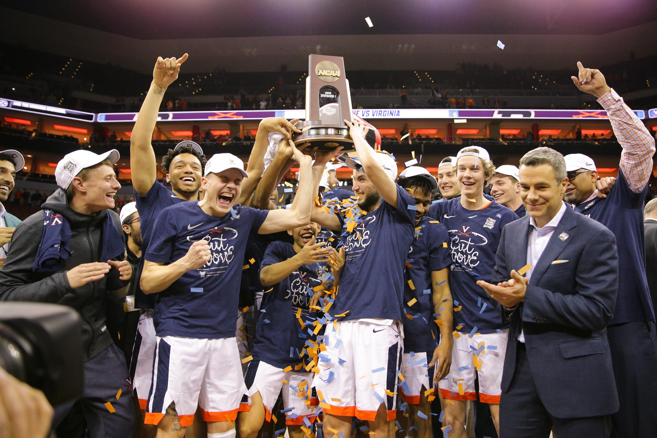 UVA basketball team holding up the NCAA championship trophy