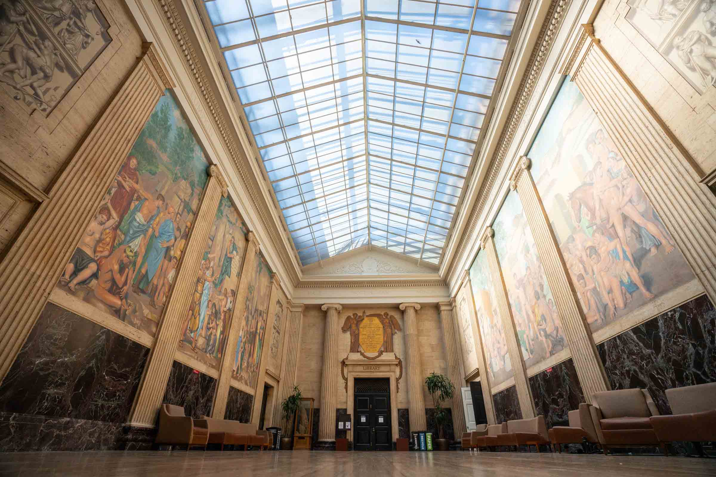 empty Hallway with large floor to ceiling paintings on the wall