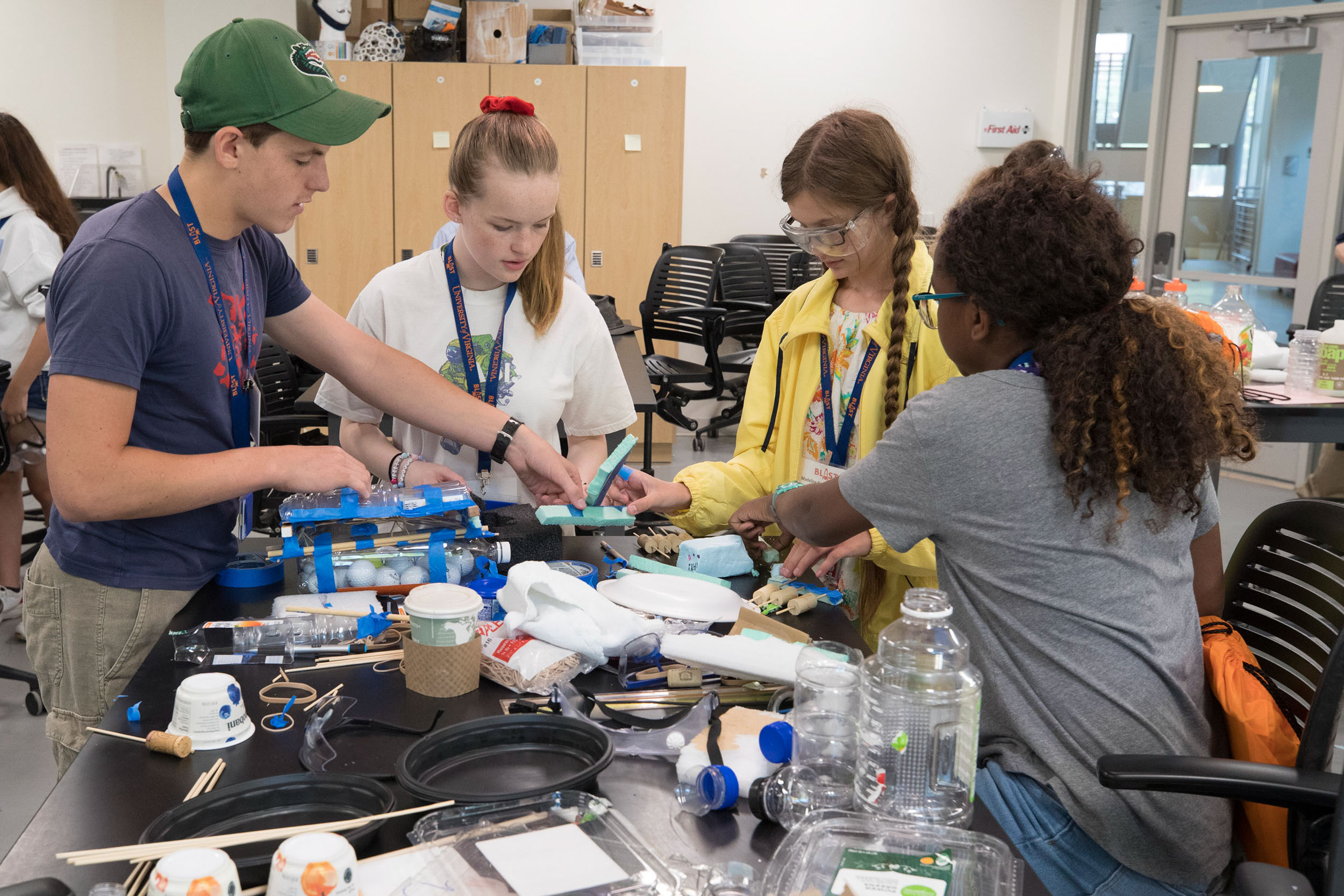 Students working at a table together to build something