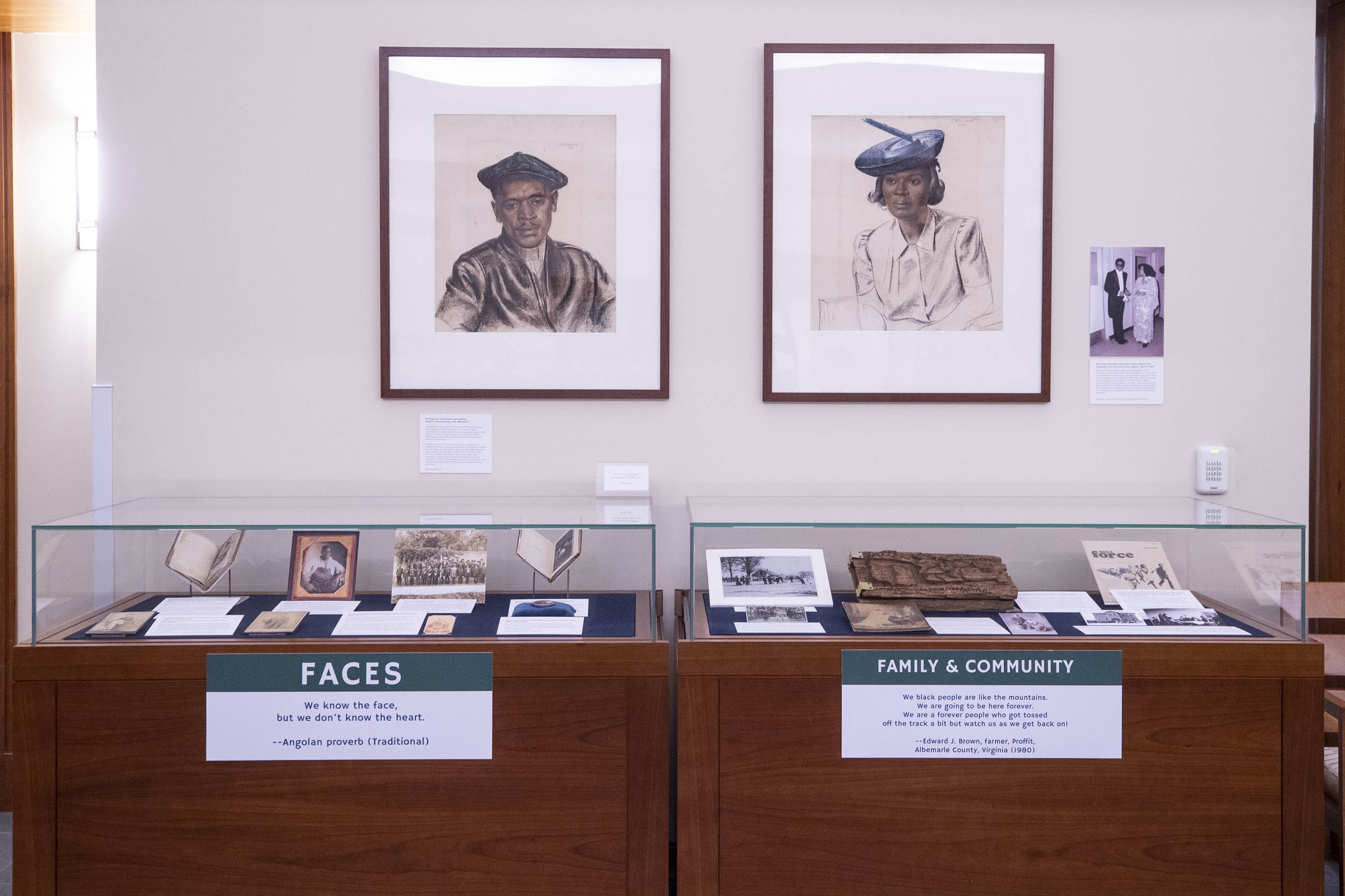 An exhibit of African Americans.  Glass cases and a wall with hanging pictures
