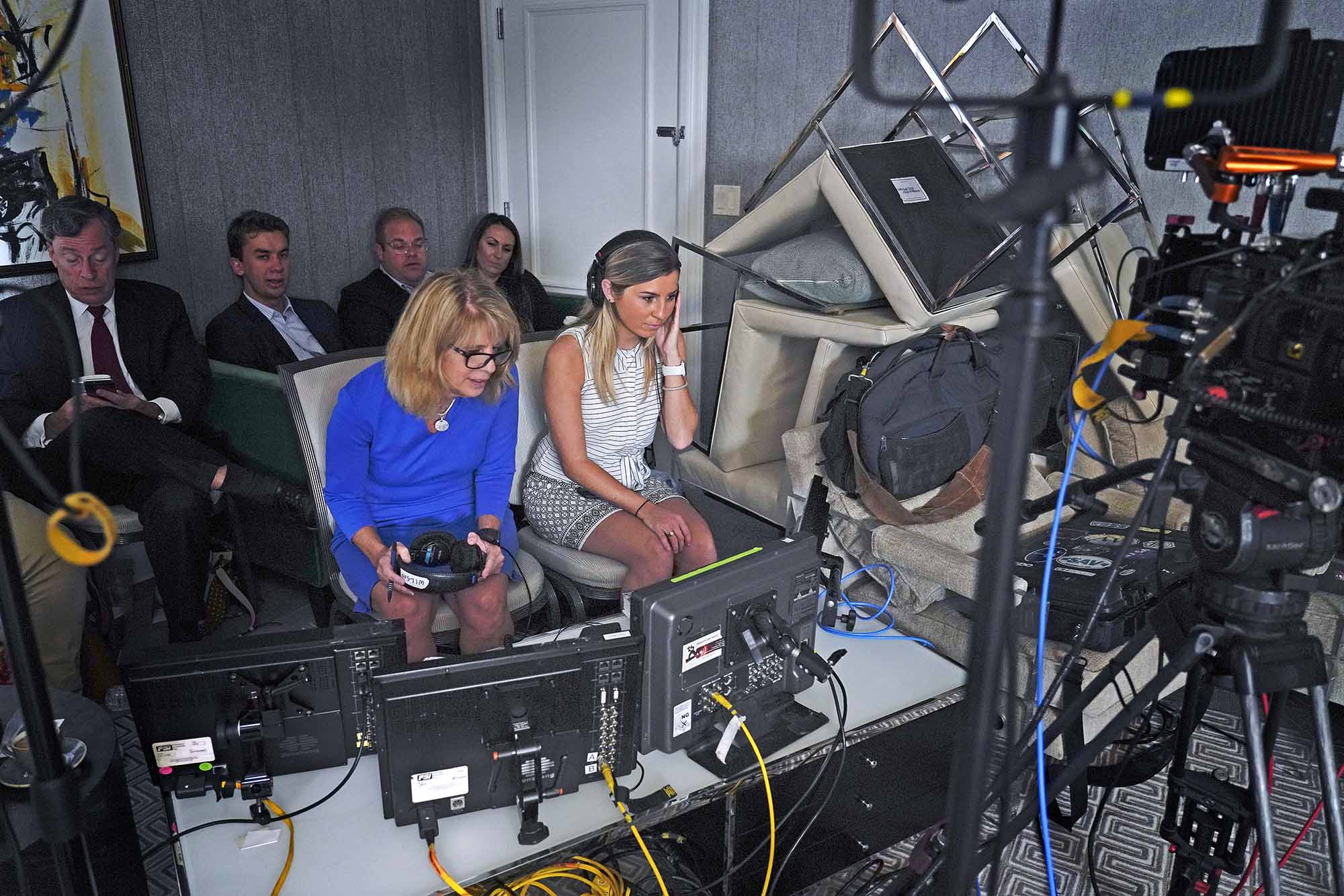 Mary Hager, left, watching tv monitors