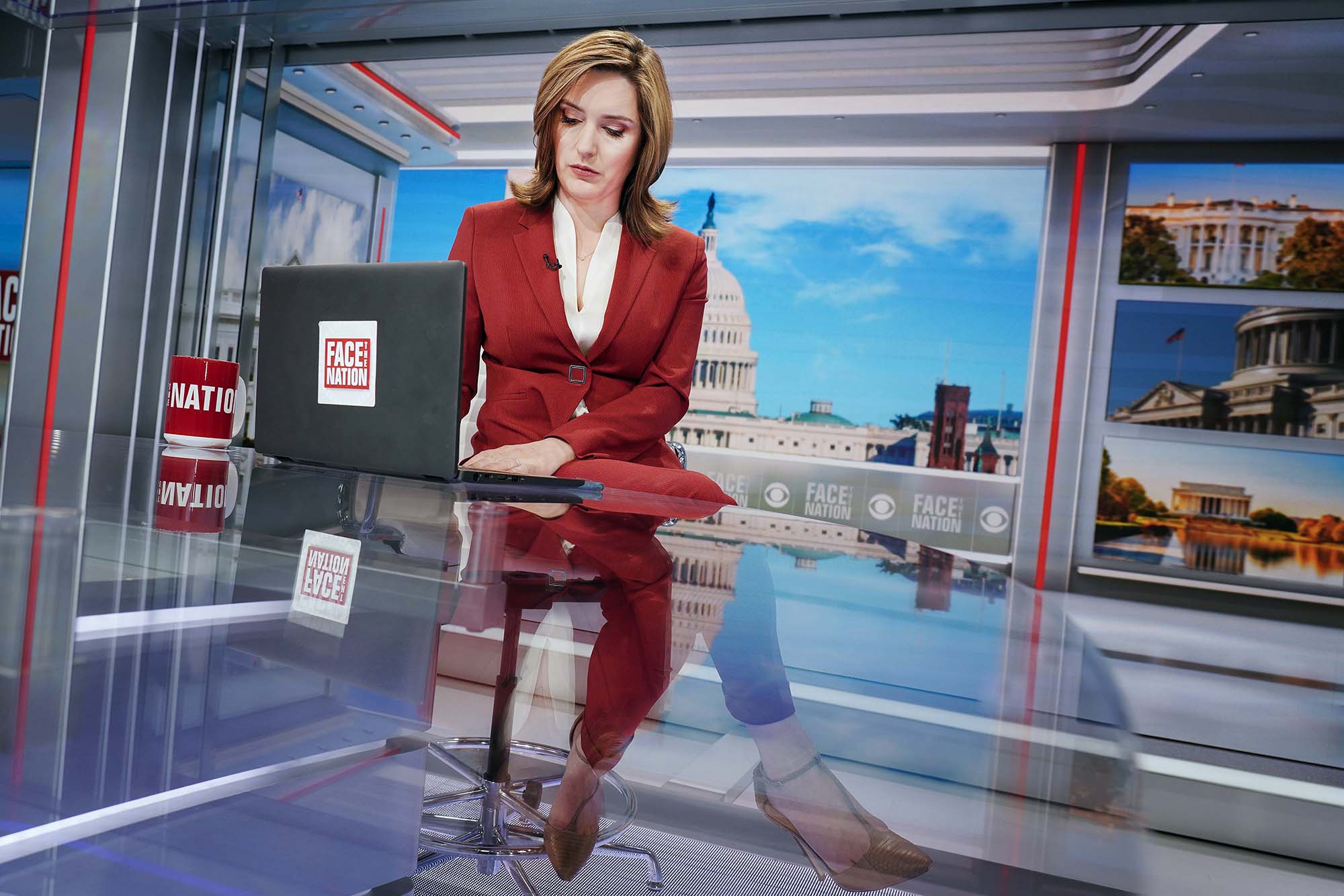 Brennan sitting at a reporters desk on Face the Nation