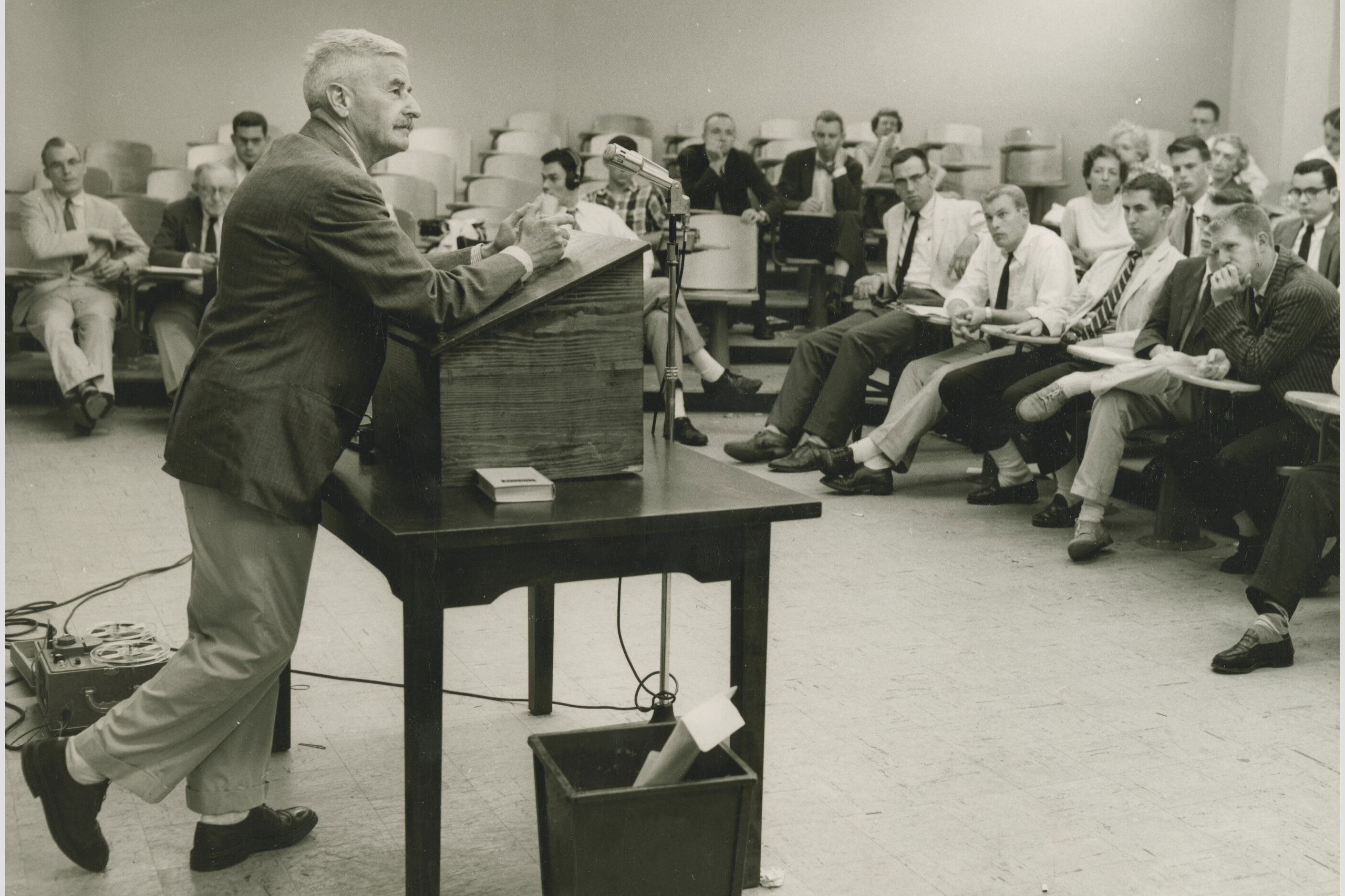 Faulkner standing at a podium talking to a class