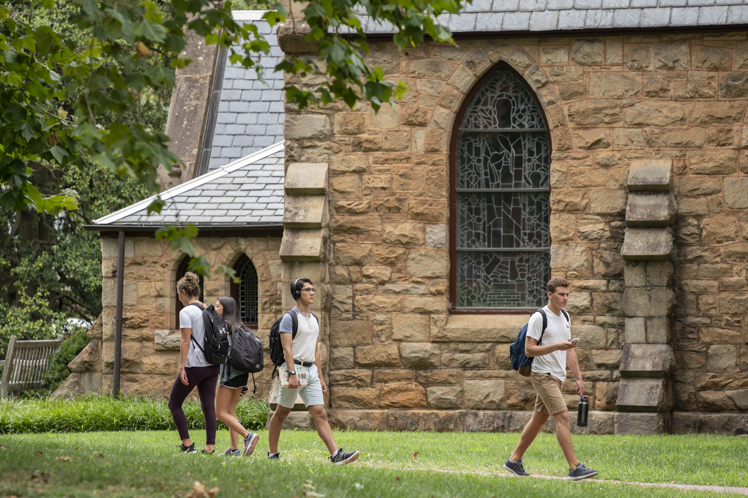 Students walking on sidewalks outside of the UVA Chapel