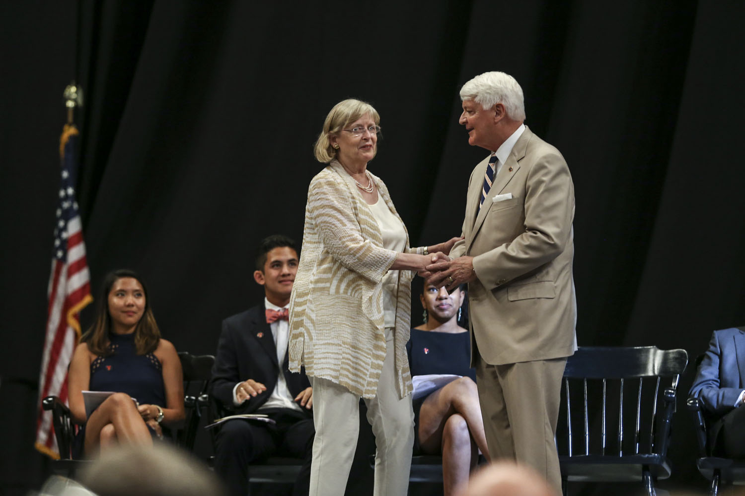 C. Thomas Faulders III, right, shakes Dorothy “Dorrie” K. Fontaine, lefts hand on stage