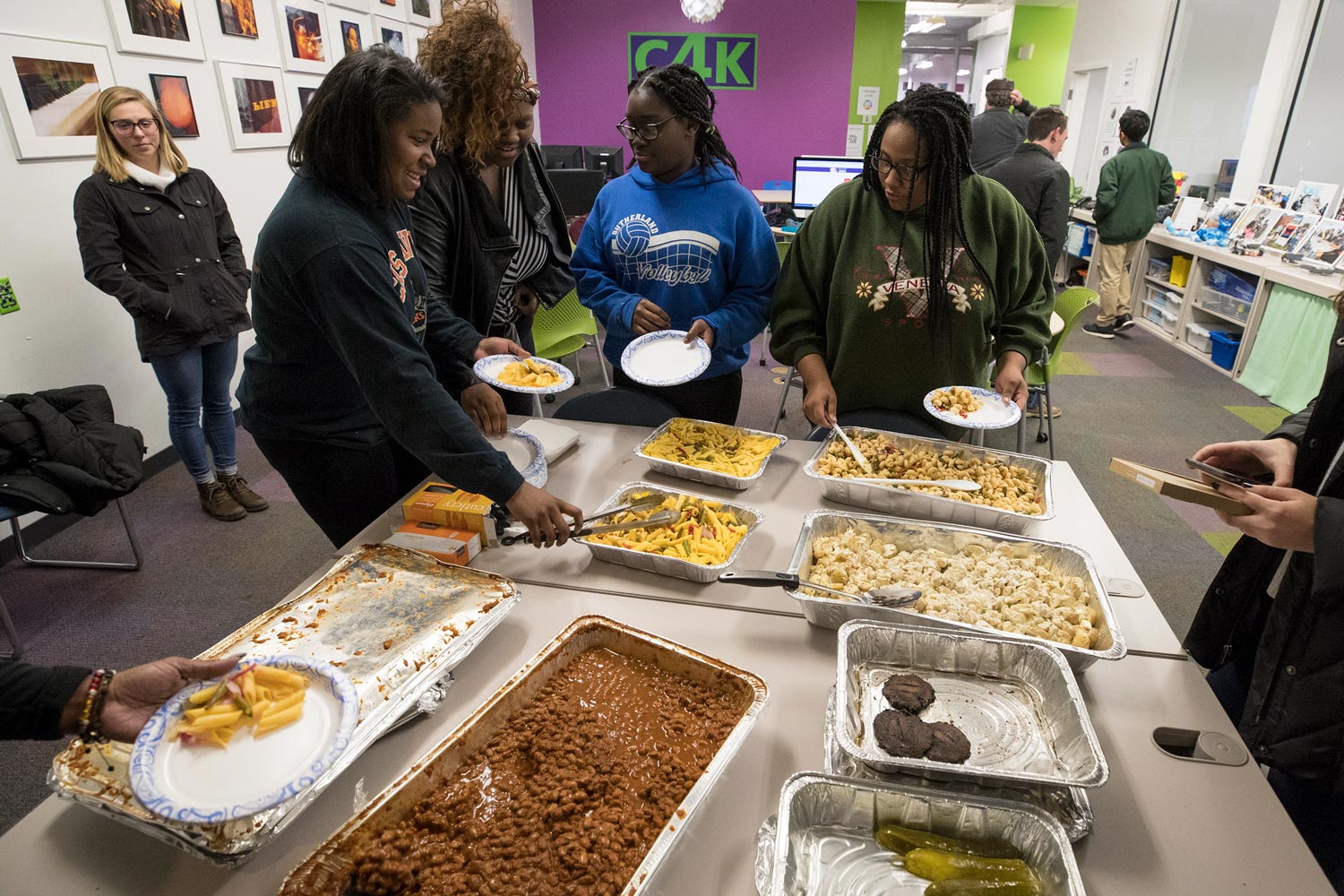 Niedia Washington, second from the left, getting food with her friends at a potluck