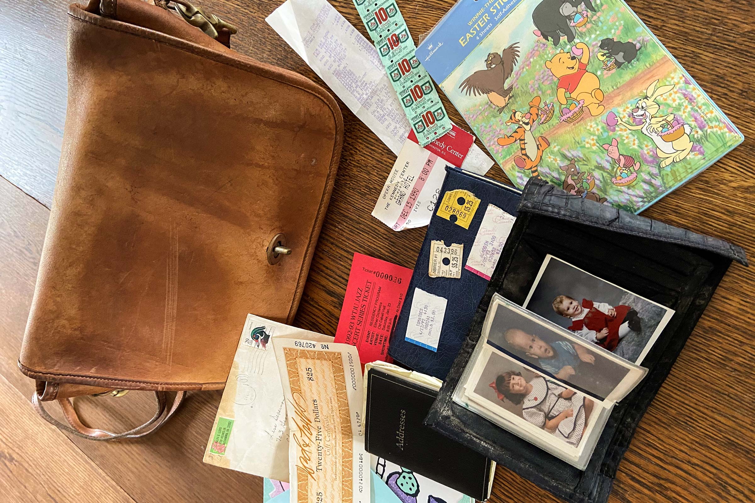 Table filled, with a purse, baby pictures, tickets,green stamps, and baby book
