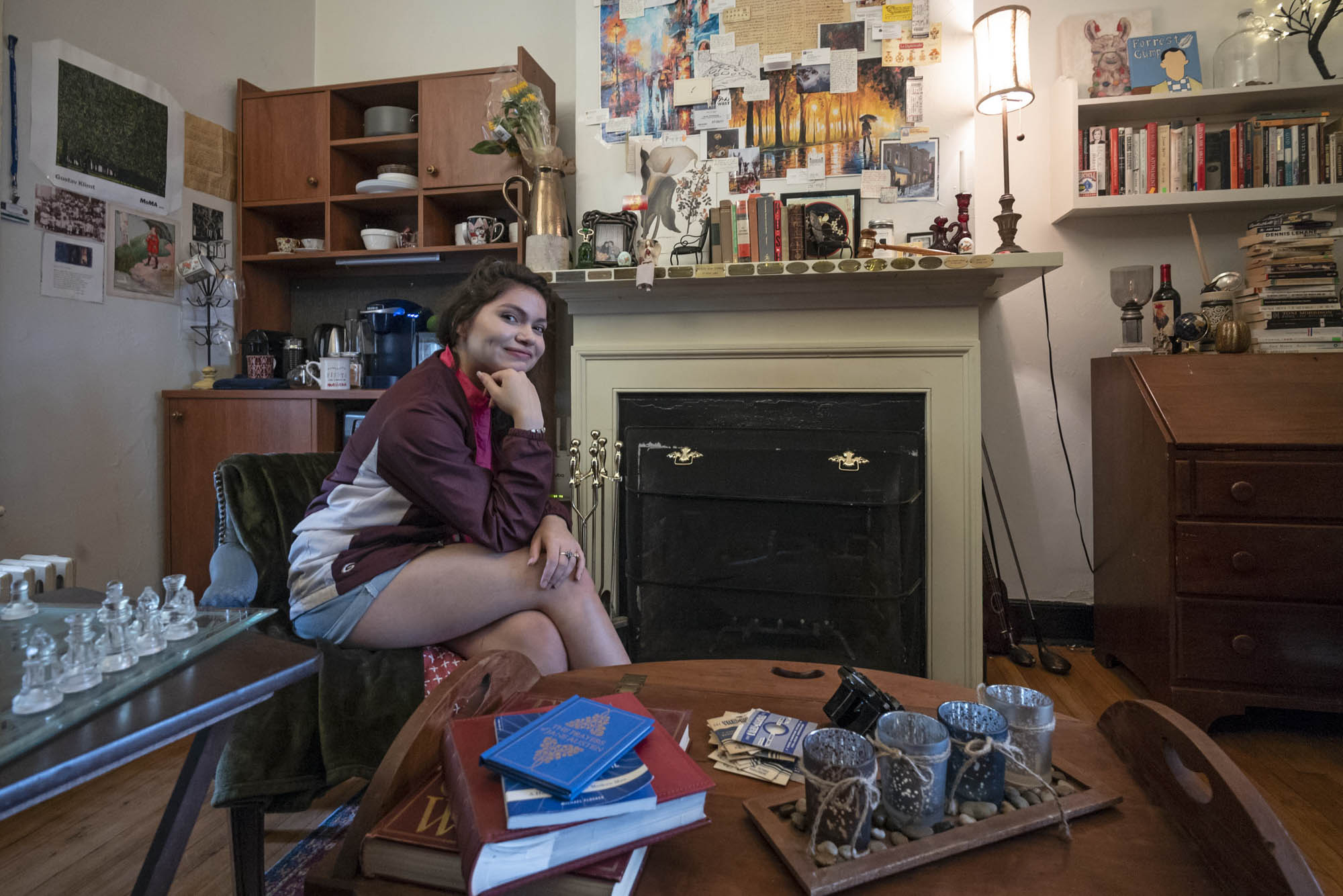 Francesca Callicotte sits in a chair in her room on the Lawn