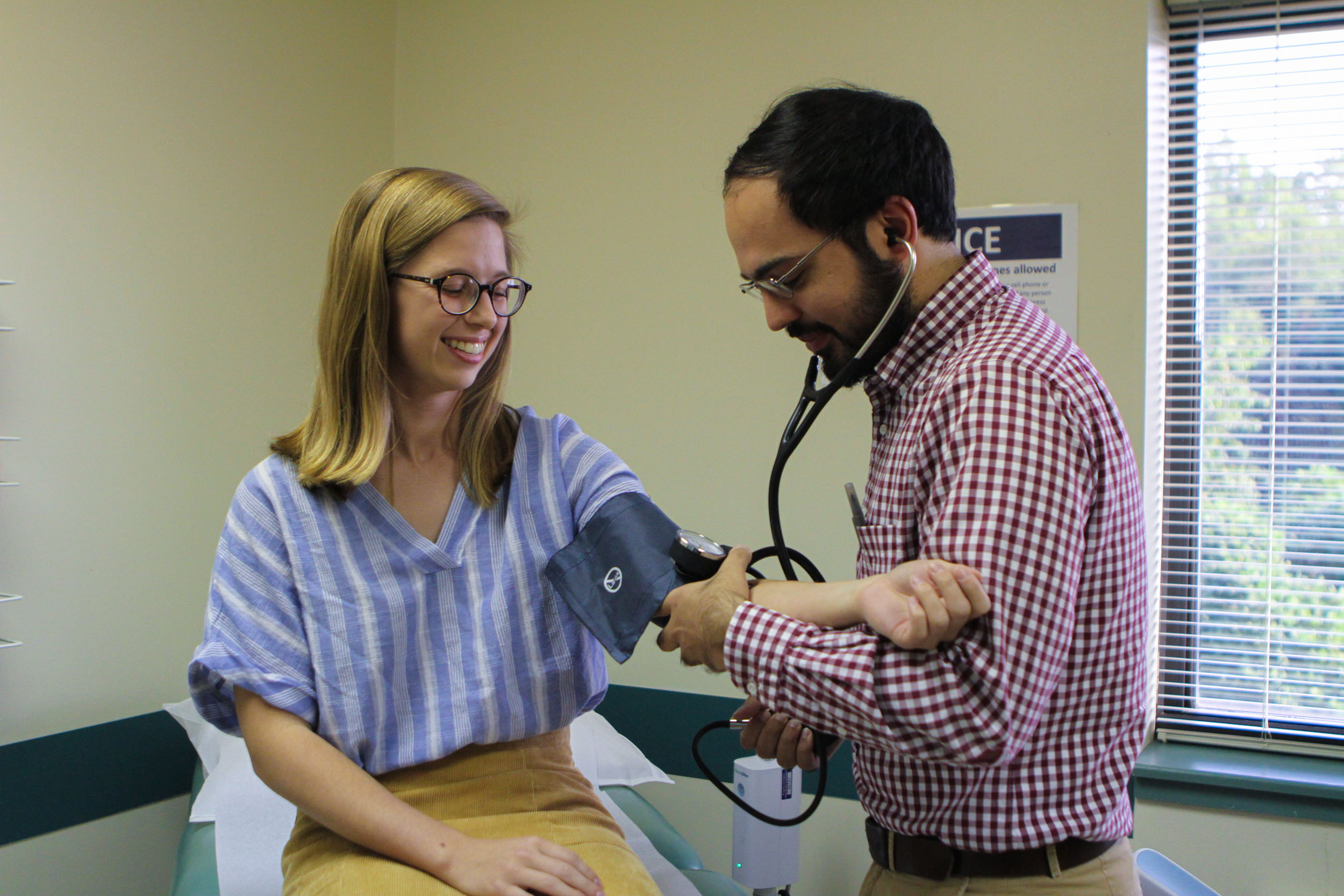 Healthcare professional taking a patients blood pressure