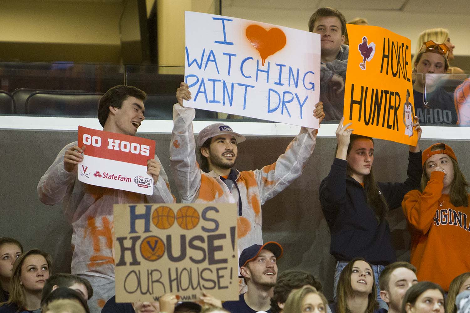 Sign reading "I like watching paint dry"  held by college students