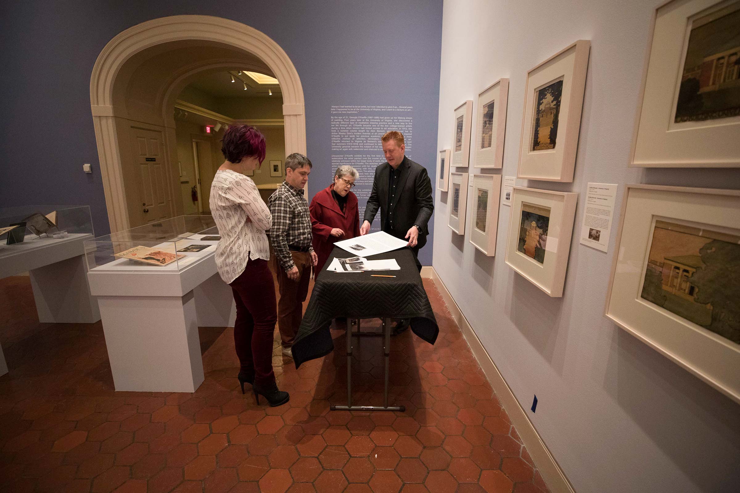 Left to right, Ph.D. student Meaghan Walsh, Jonathan Chance, Elizabeth Turner, and  Matthew McLendon look at art pieces on a table