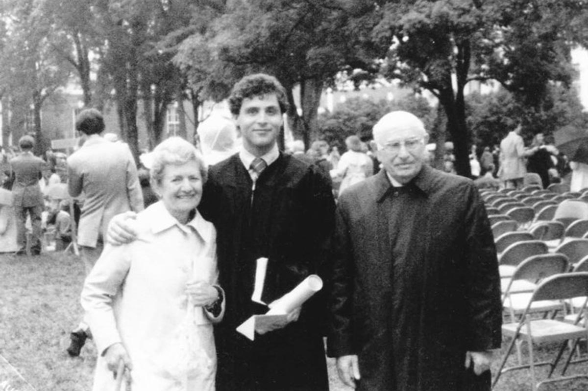 Black and white photo of Glenn Kirwin  with his grandparents at a UVA graduation