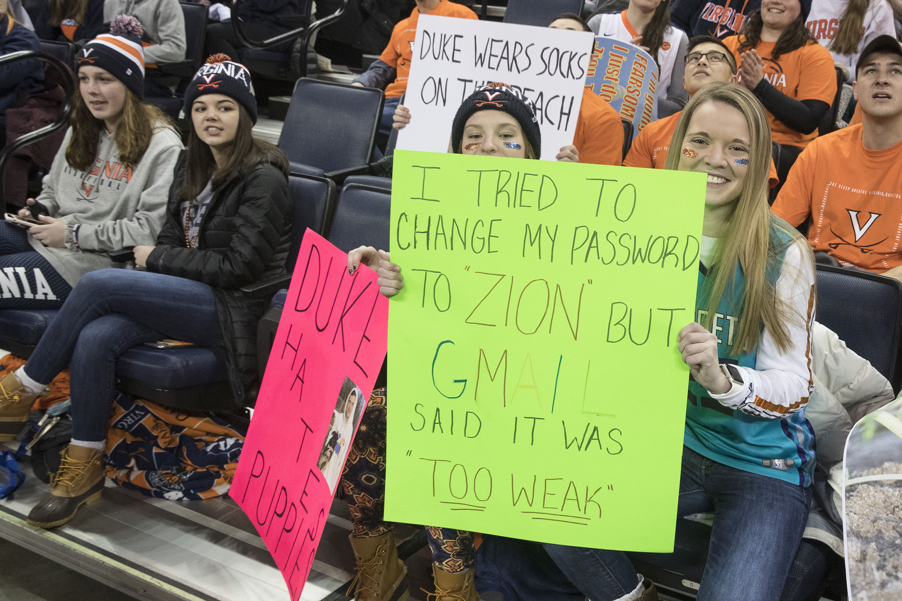 Fans holding a sign that reads: I tried to change my password to "Zion" but GMAIL said it was "Too Weak"