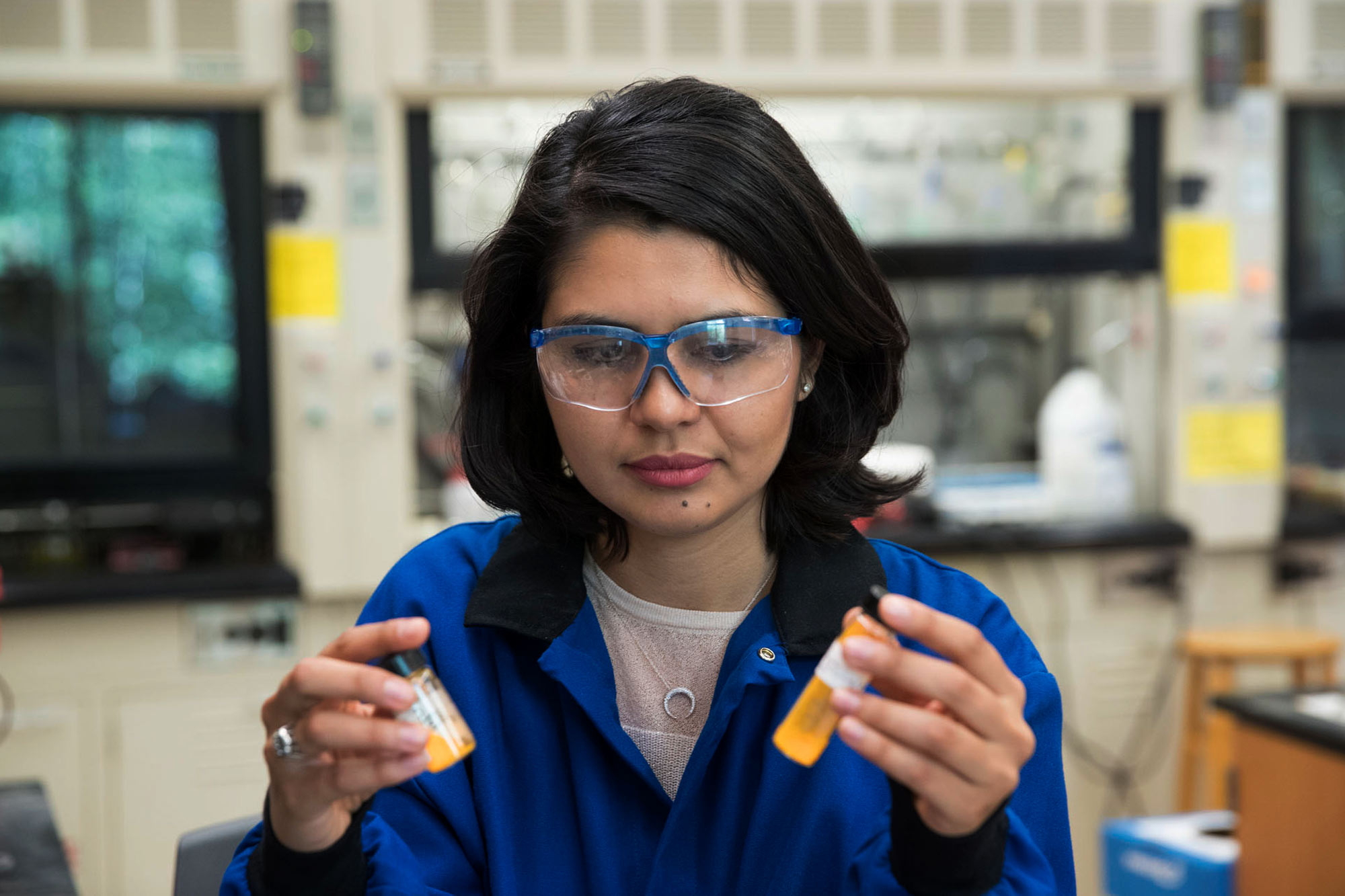 Golara Haghtalab holds two vials of liquid in lab