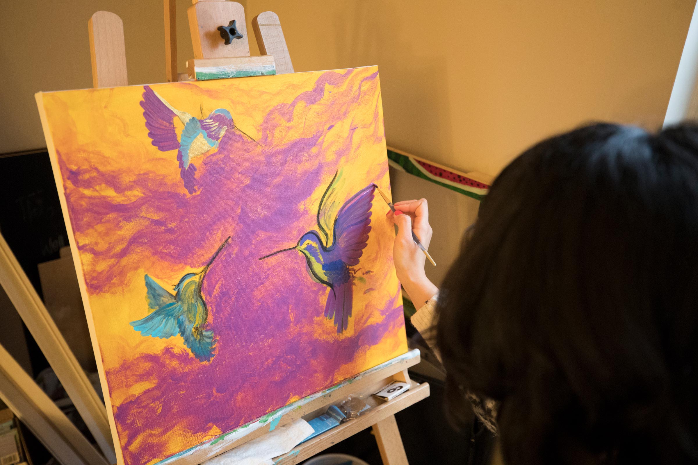 Student painting humming birds