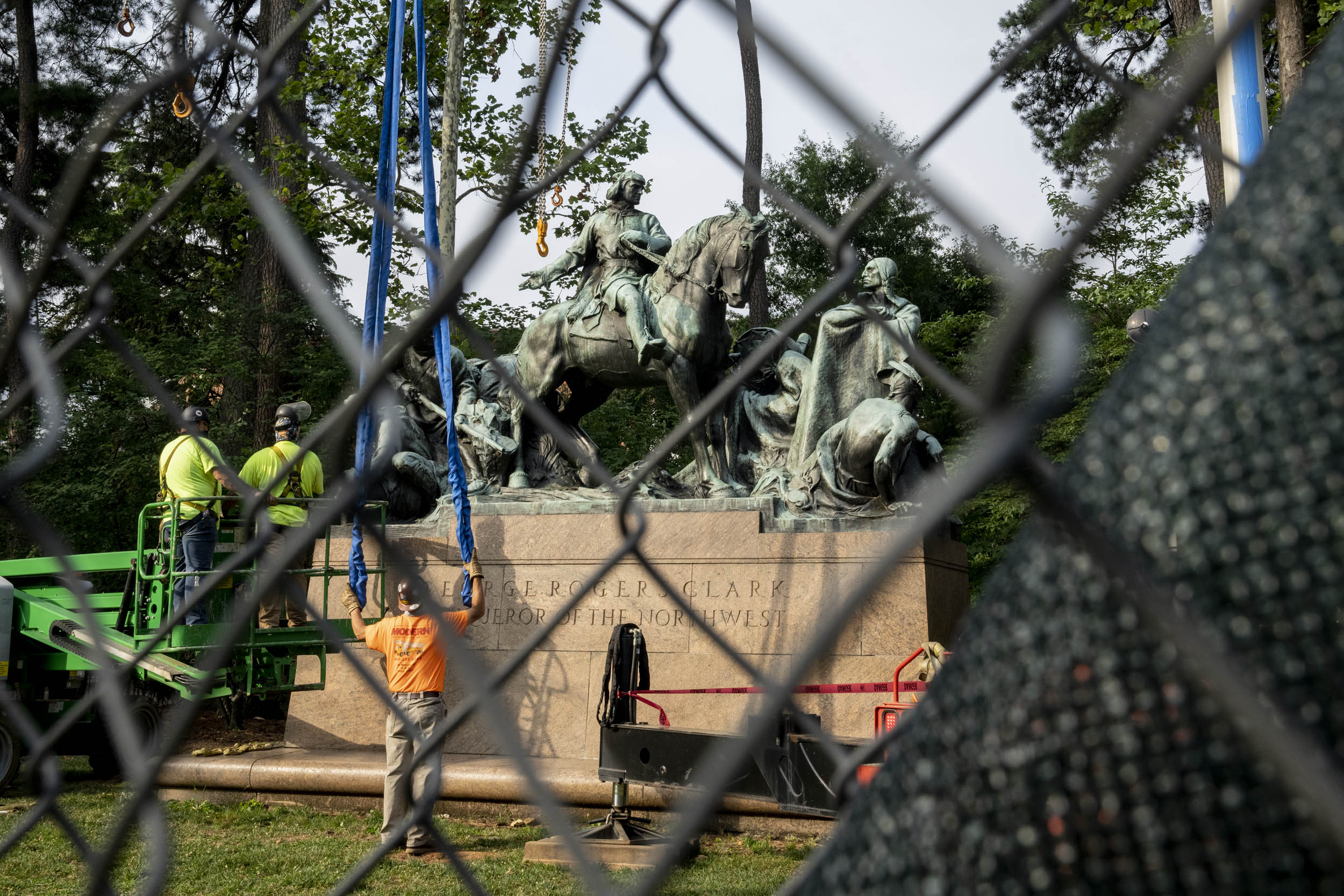 Looking at the George Rogers Clark Statue being removed through a chainlink fence