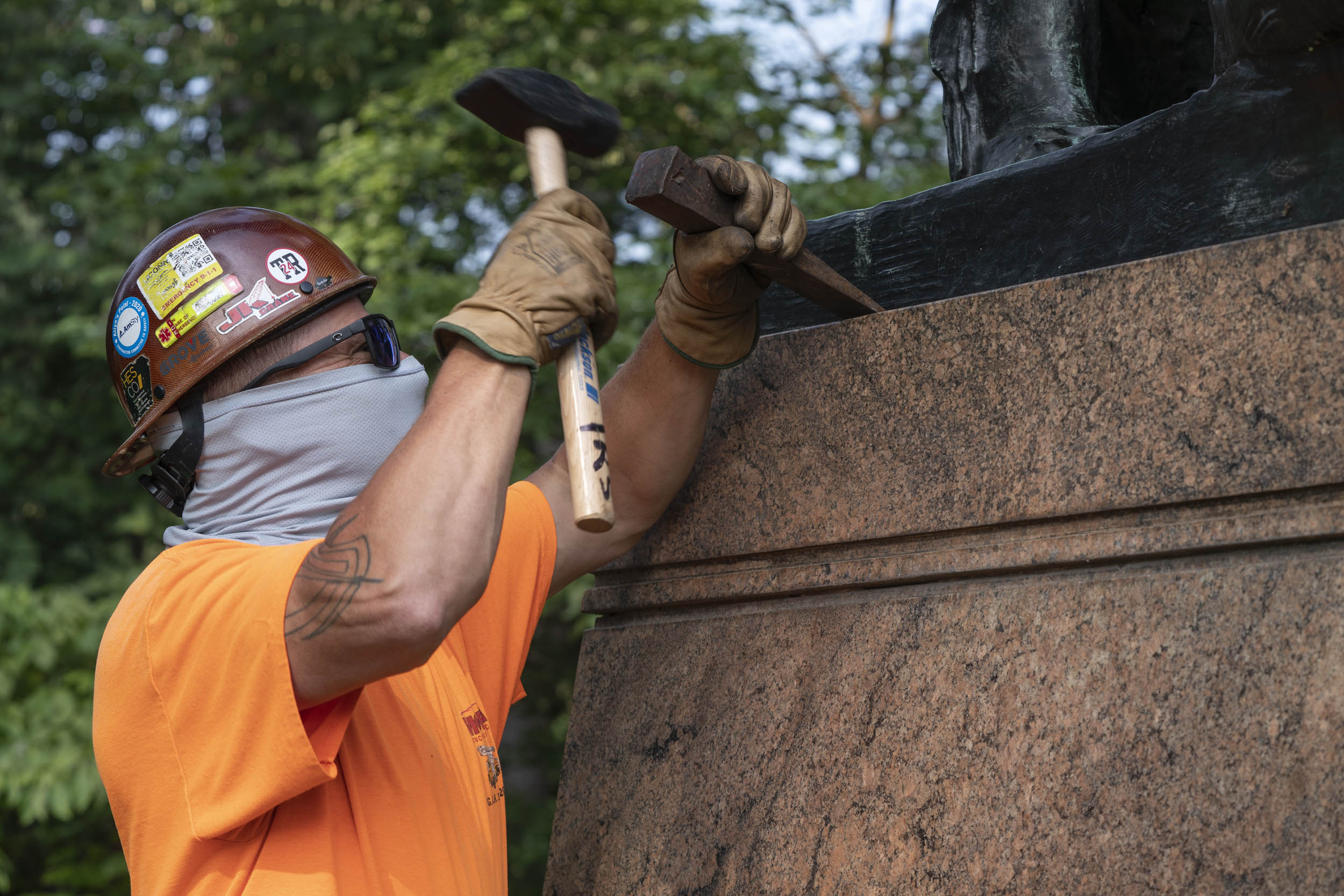 Construction working releasing the Clark statue seal so that it can be removed