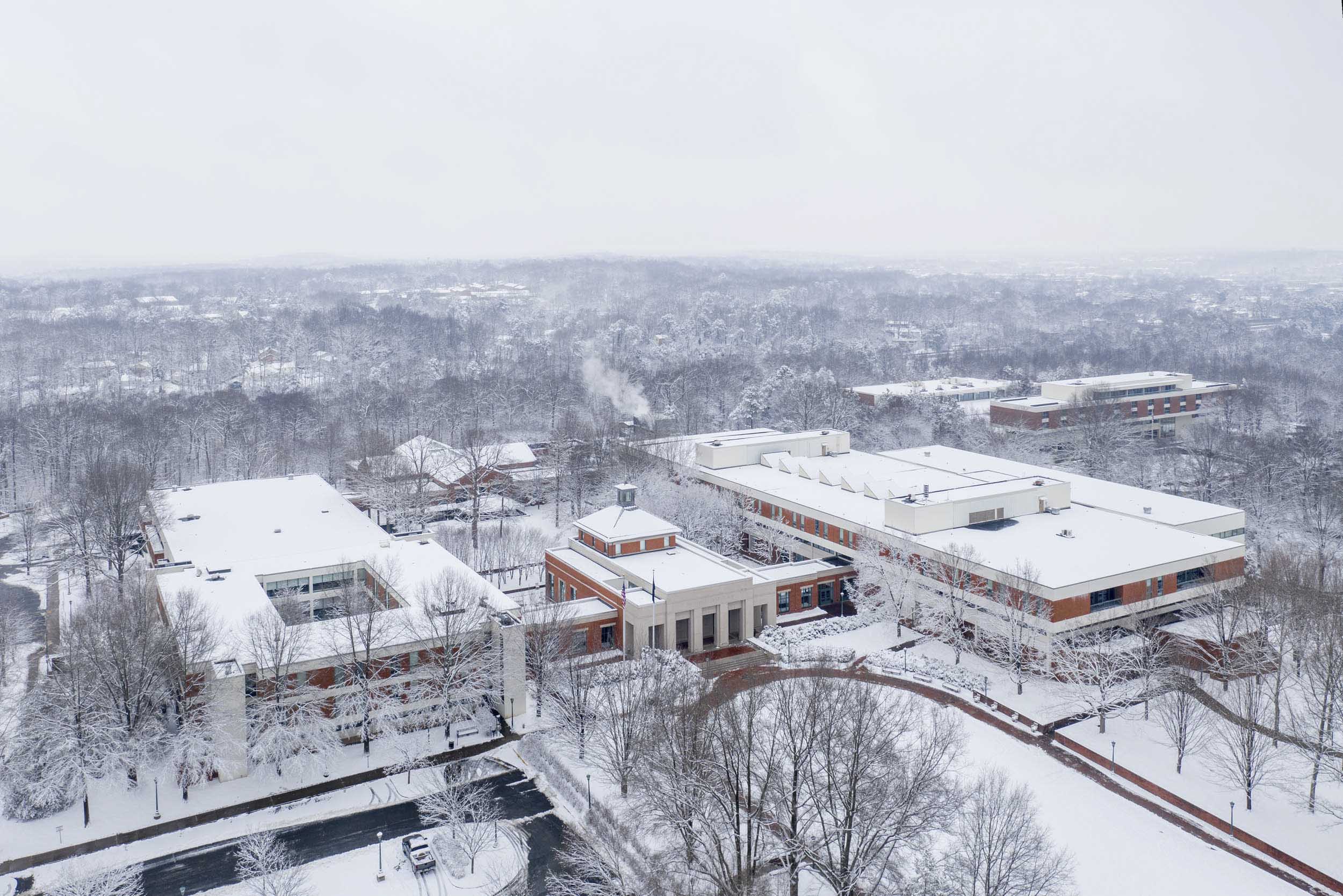 Arial view of snowing covering a building on Grounds