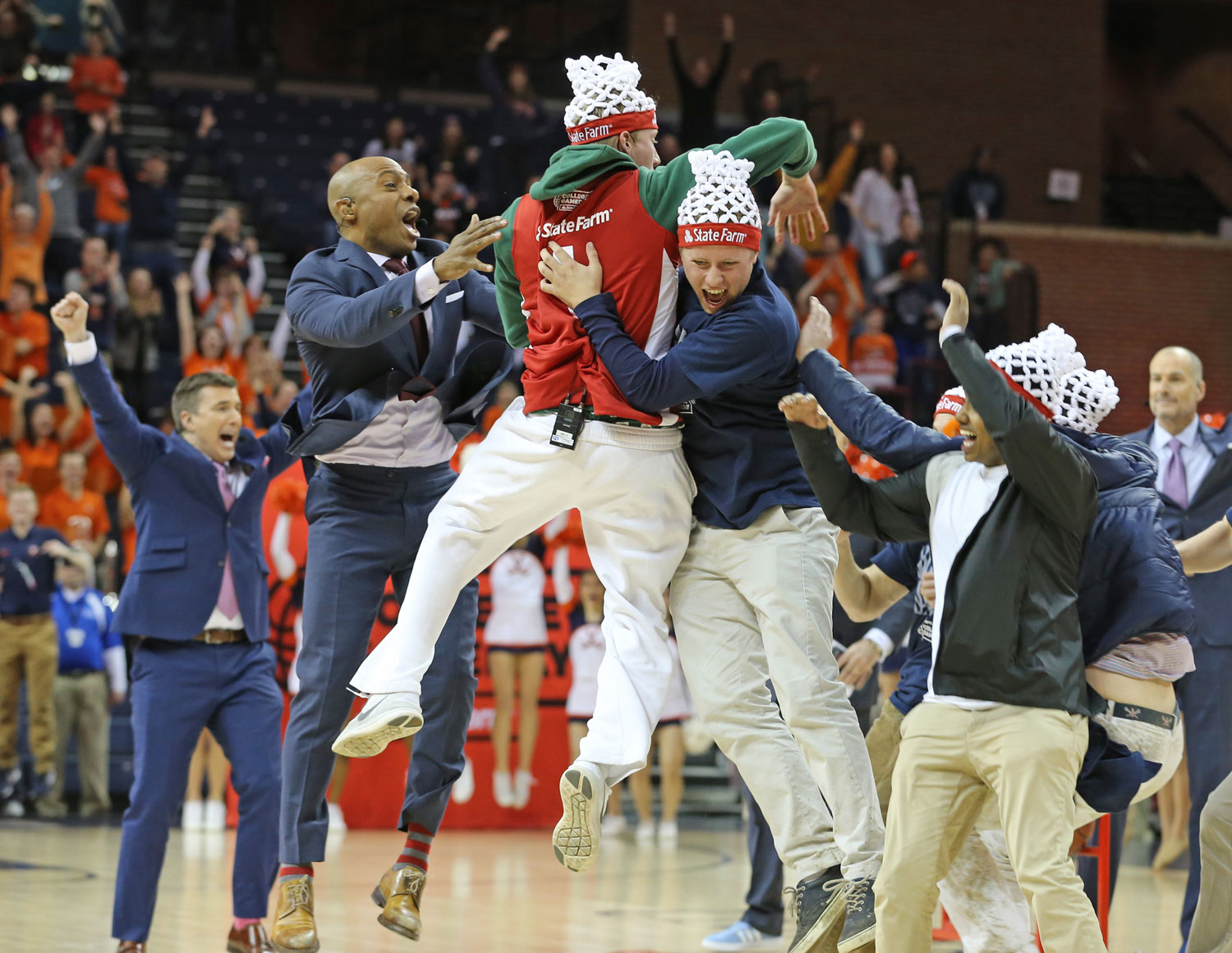 Angus Binnie (center) and others celebrate after making last year’s half-court shot