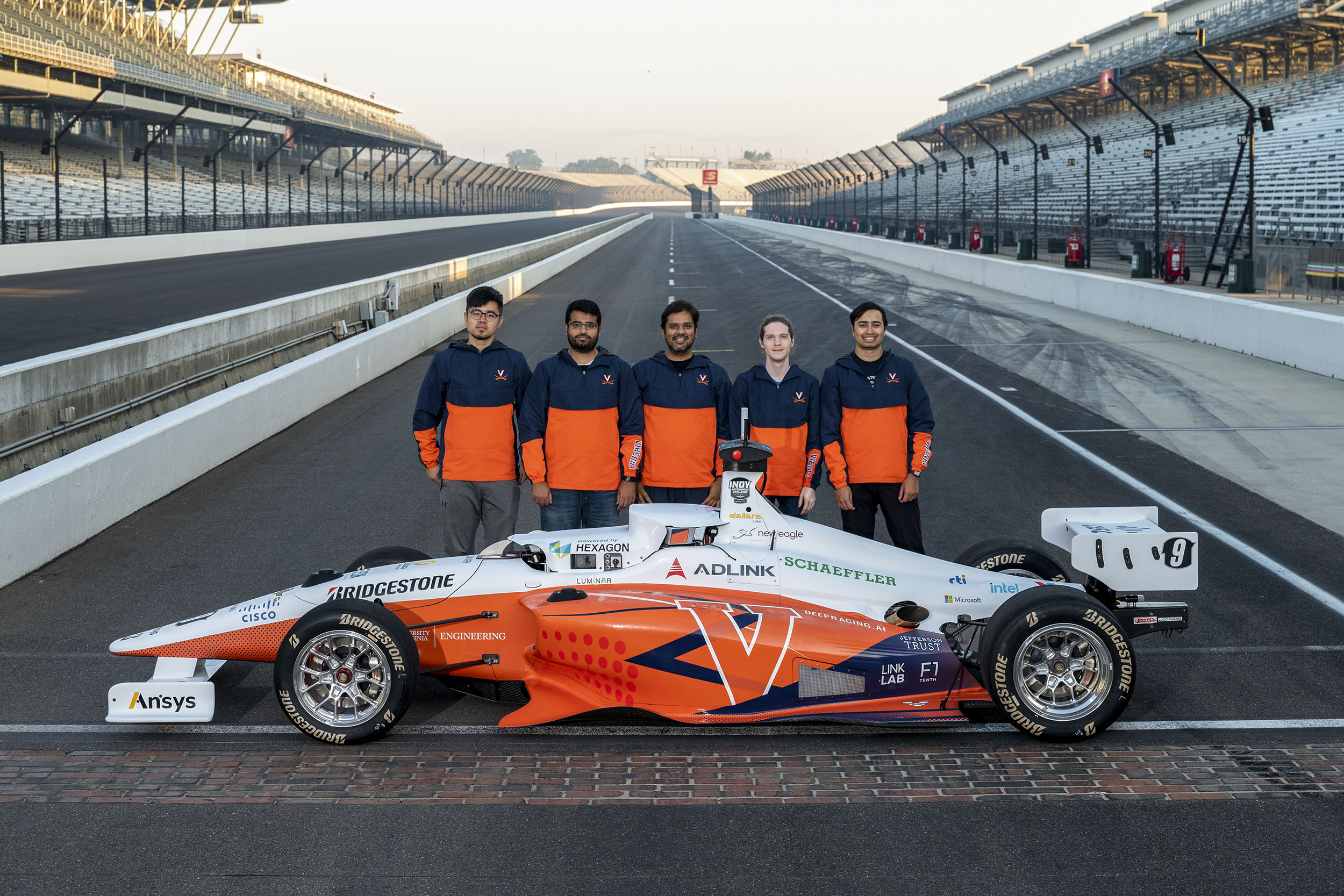 UVA Autonomous Racing team posing with their Autonomous car on the Indianapolis Motor Speedway