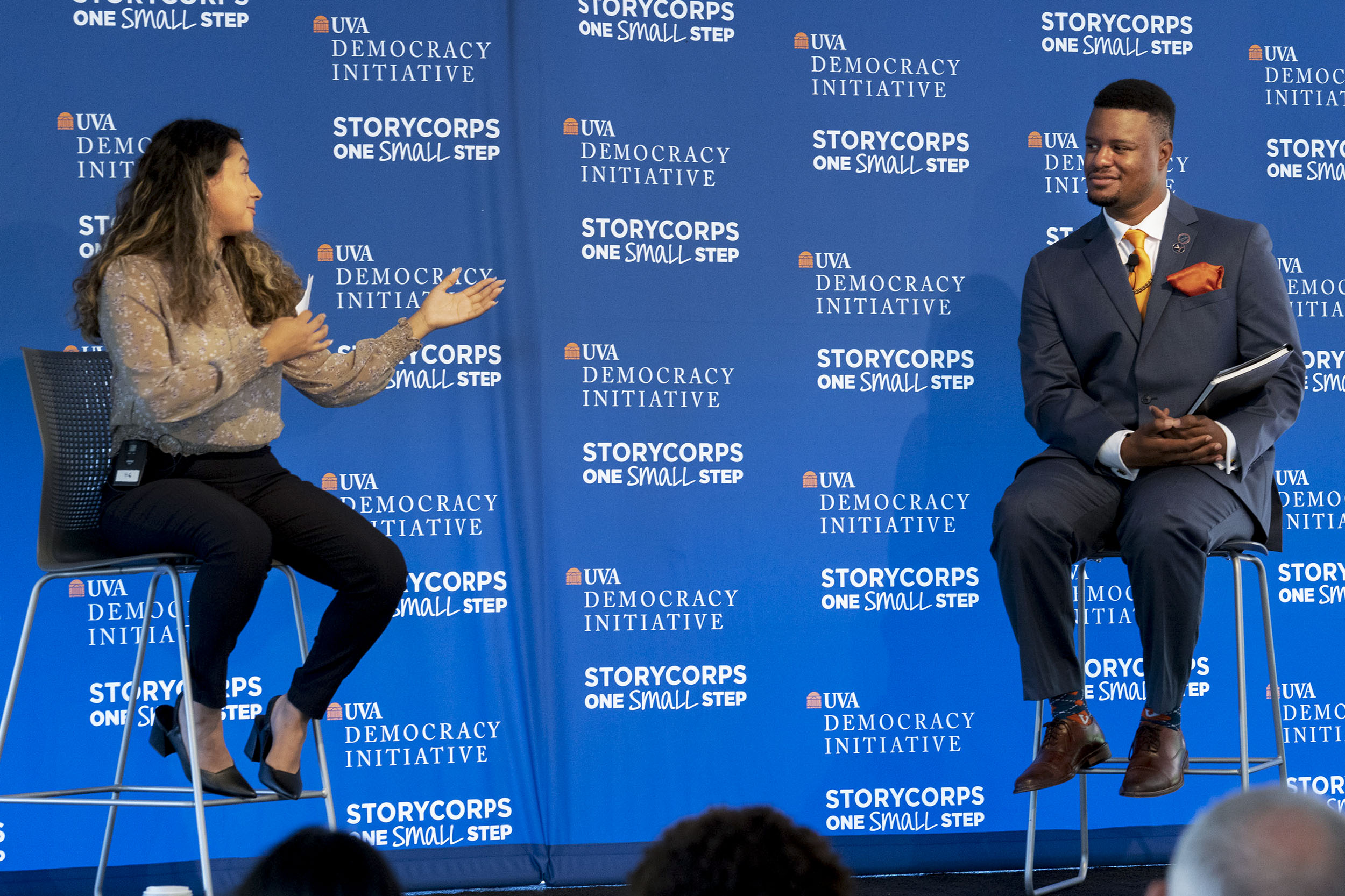 Diana Moreno (left) and Marquis Rice(right) speaking on stage to each other in front of a crowd