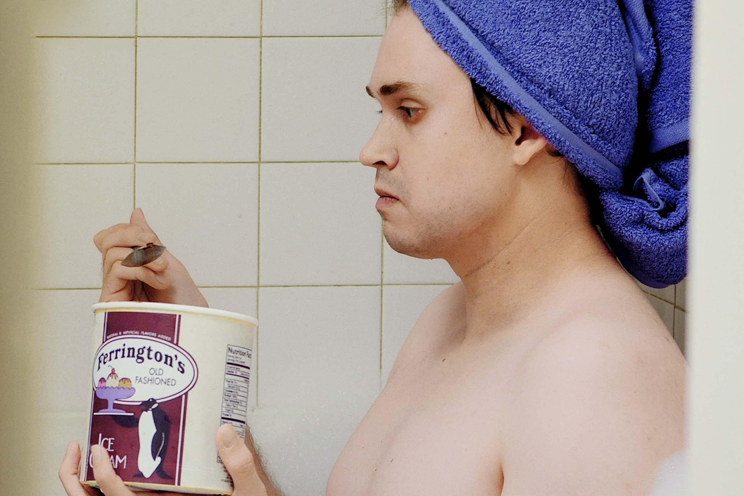 Alex Scheinman sitting in a bathtub eating ice cream during his movie