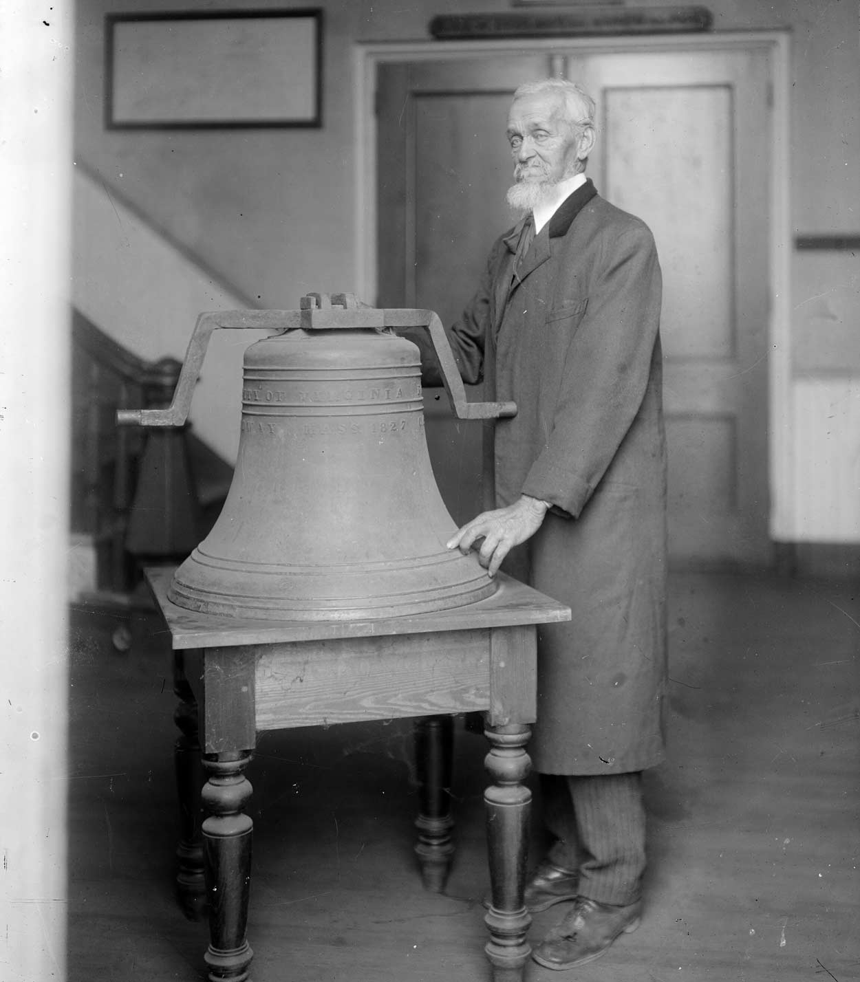 Henry Martin standing  next to a bell