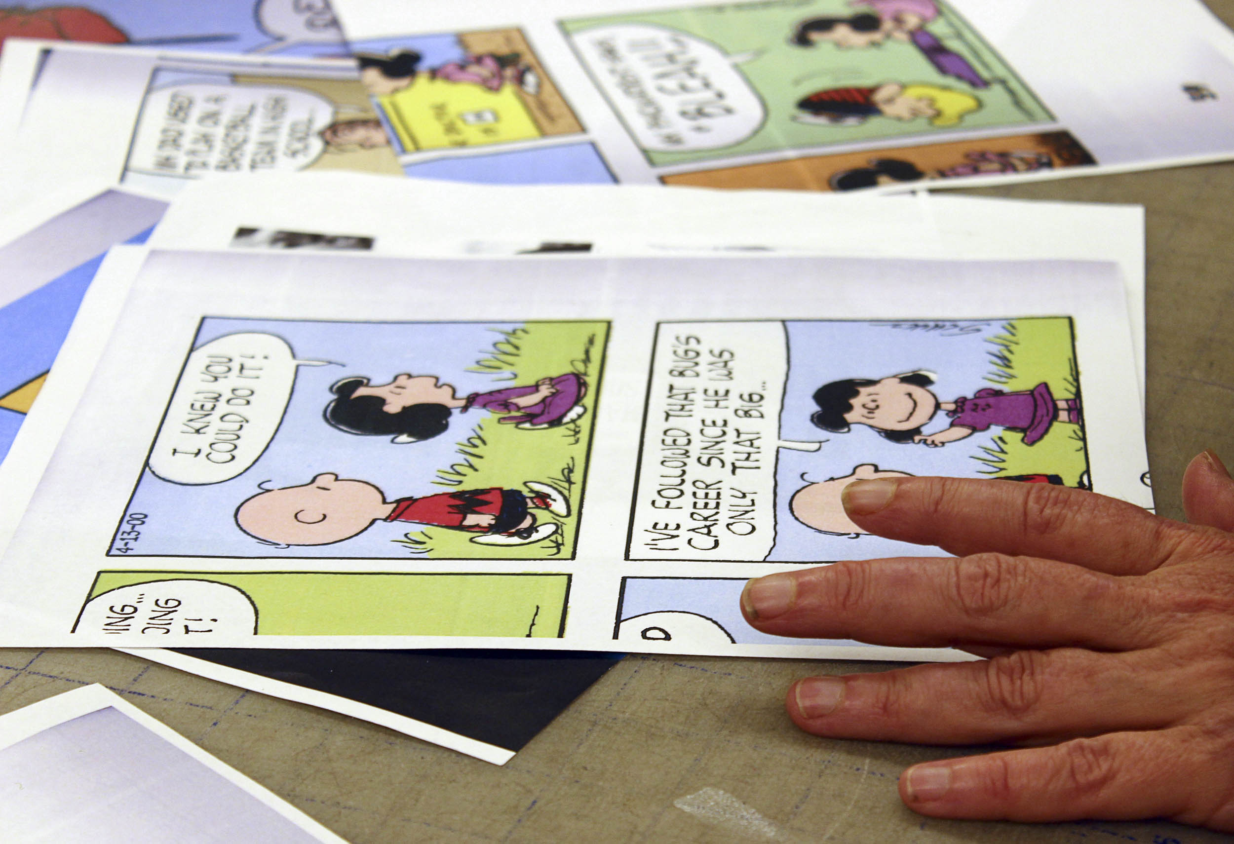 Smith flips through inspirations for the costumes in “You’re a Good Man, Charlie Brown,” which ran this July.