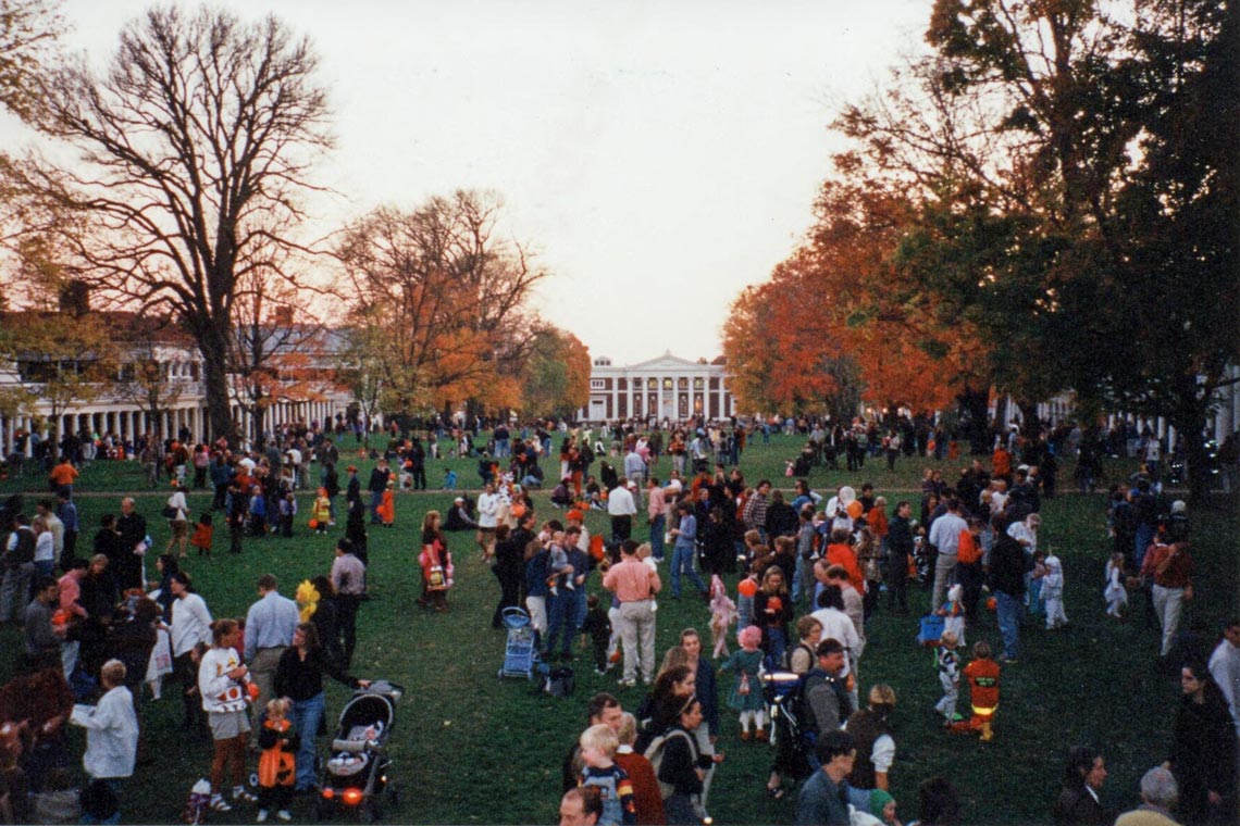 A crowd of people in costumes on the Lawn at UVA