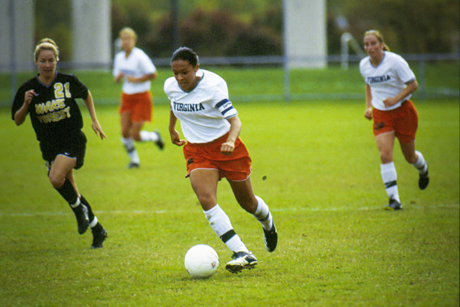 Hucles Mangano taking the soccer ball down field during a game with opponents chasing her