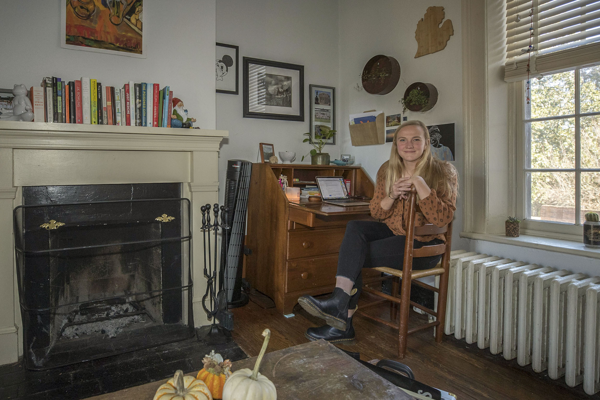 Zoe Morse Sitting at her desk in her Lawn Room