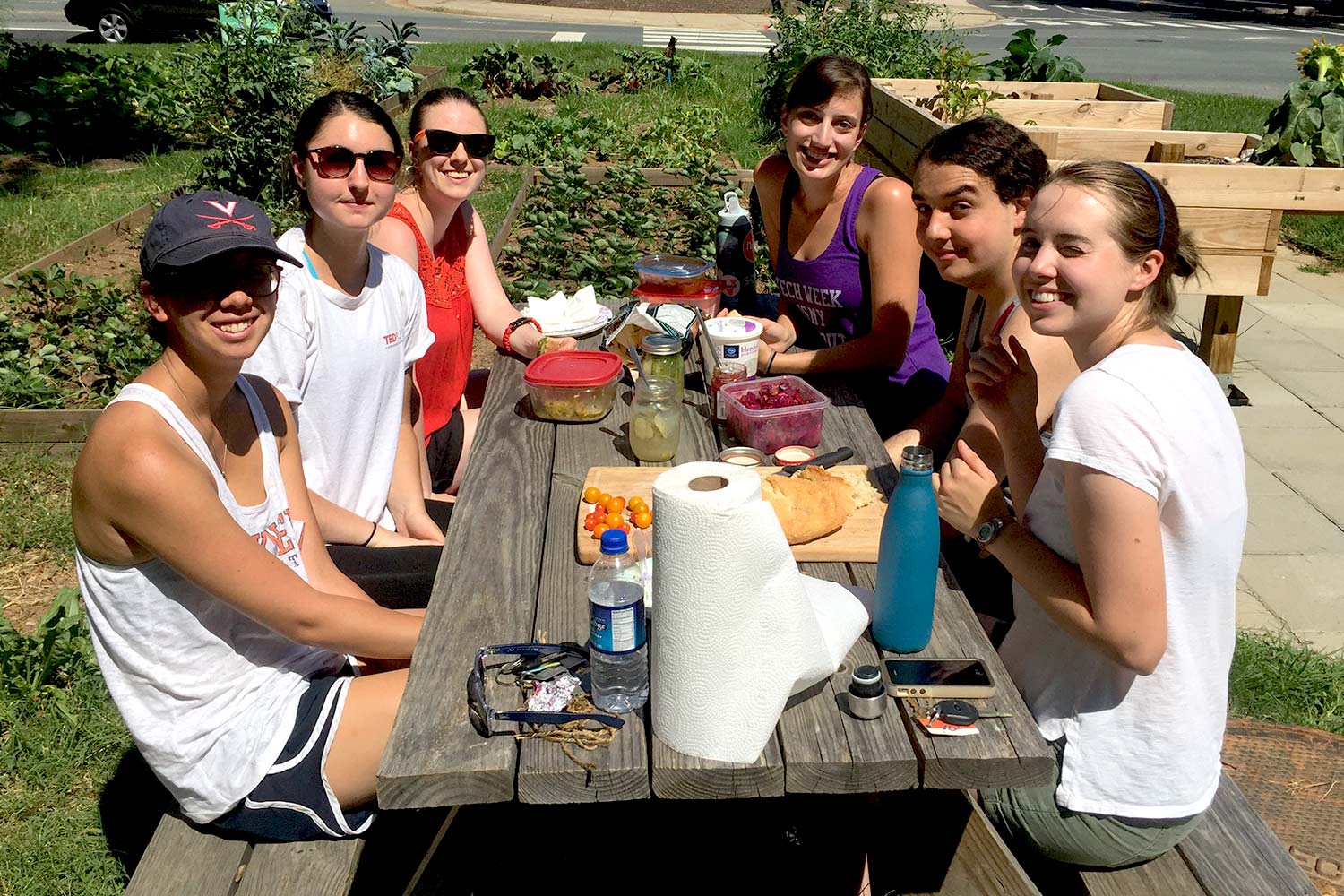 A group of volunteers reap the rewards of their work through a potluck meal featuring foods made with garden ingredients. 