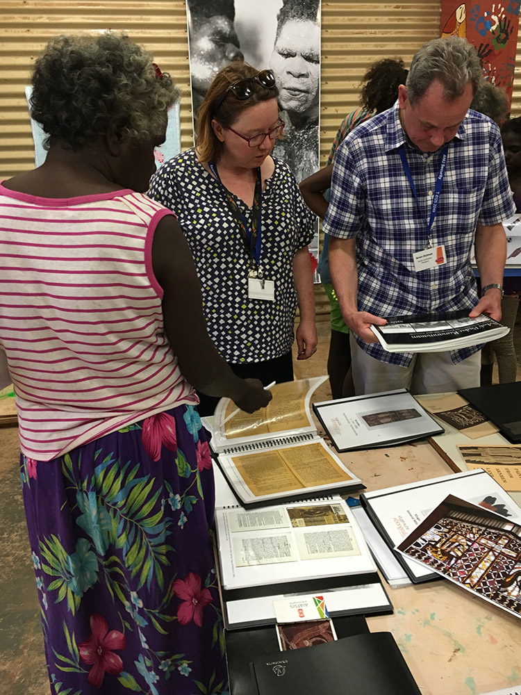 Members of the Milingimbi community and representatives from other museums browsed archival material from the Kluge-Ruhe Collection. (Photo courtesy of Margo Smith)