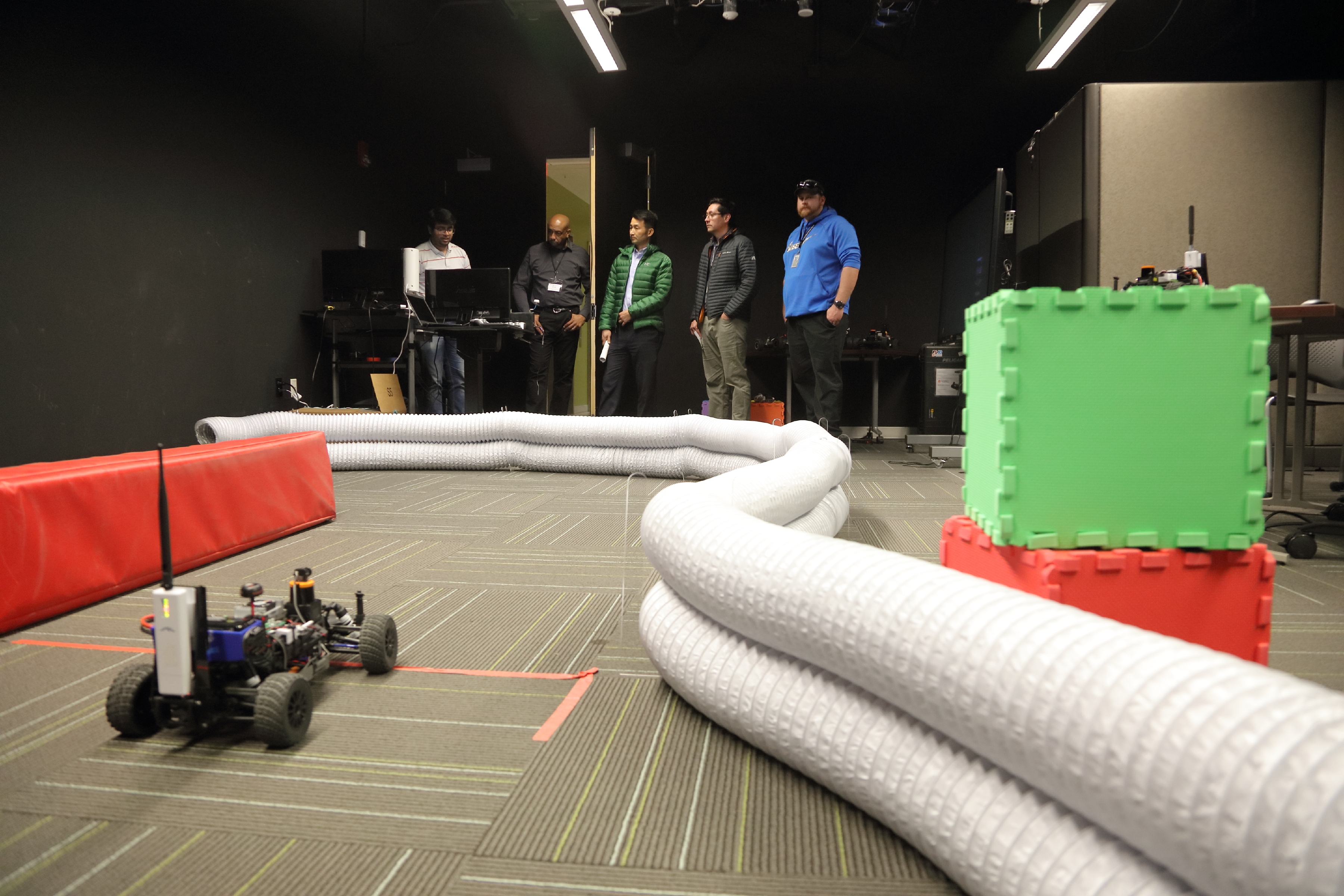 A small, autonomous vehicle navigates around a Link Lab track